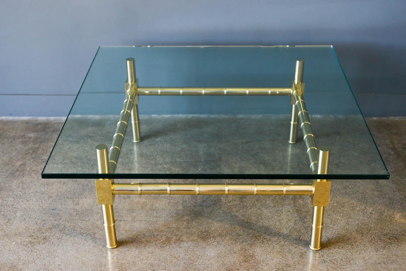 Hollywood Regency brass and glass coffee table by Mastercraft, ca. 1970. Beautifully refinished brass base with thick 3/4