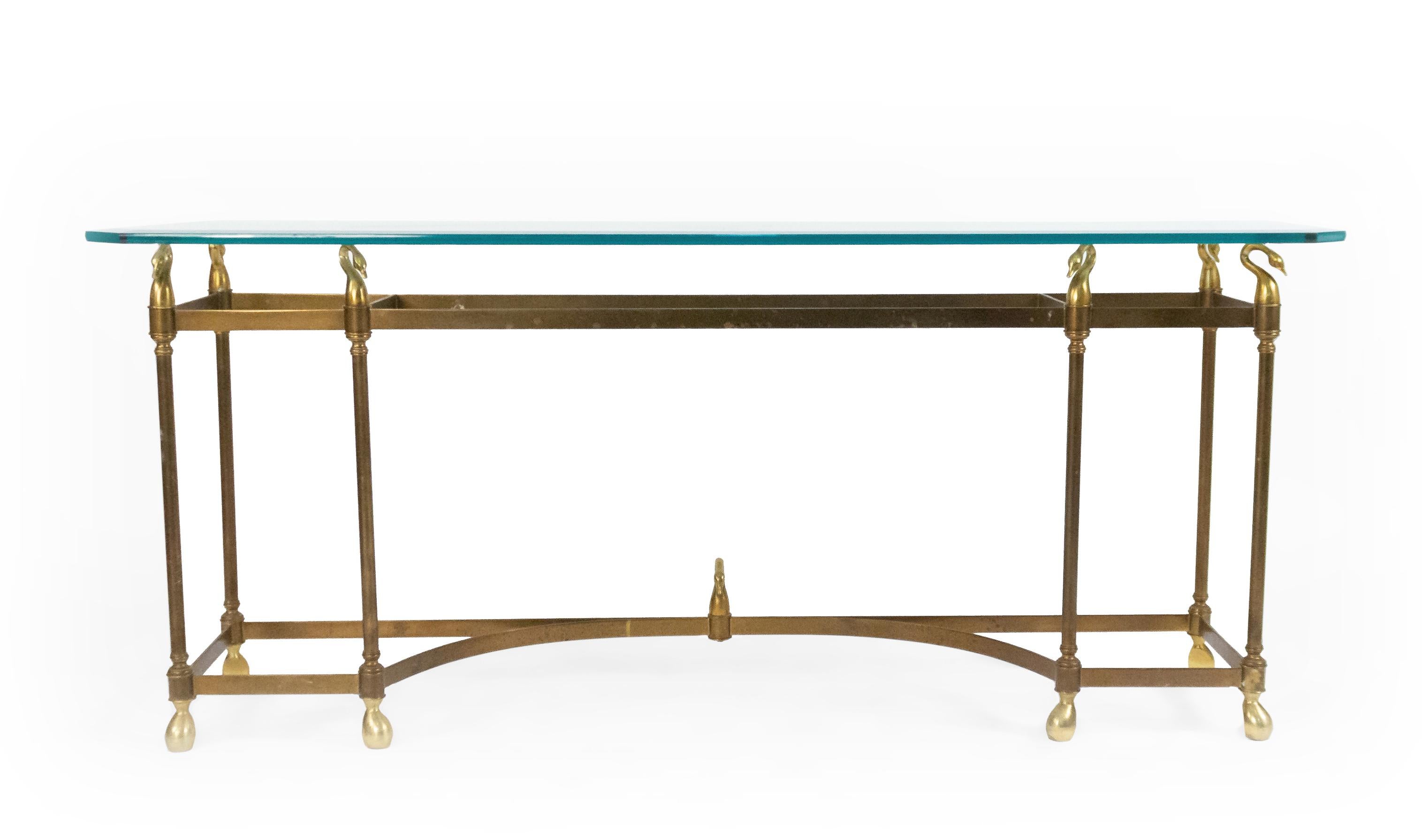 American Mid-20th Century (Hollywood Regency) brass console table with 6 legs and a glass top supported by swan finials with a stretcher base. (attributed to La Barge)