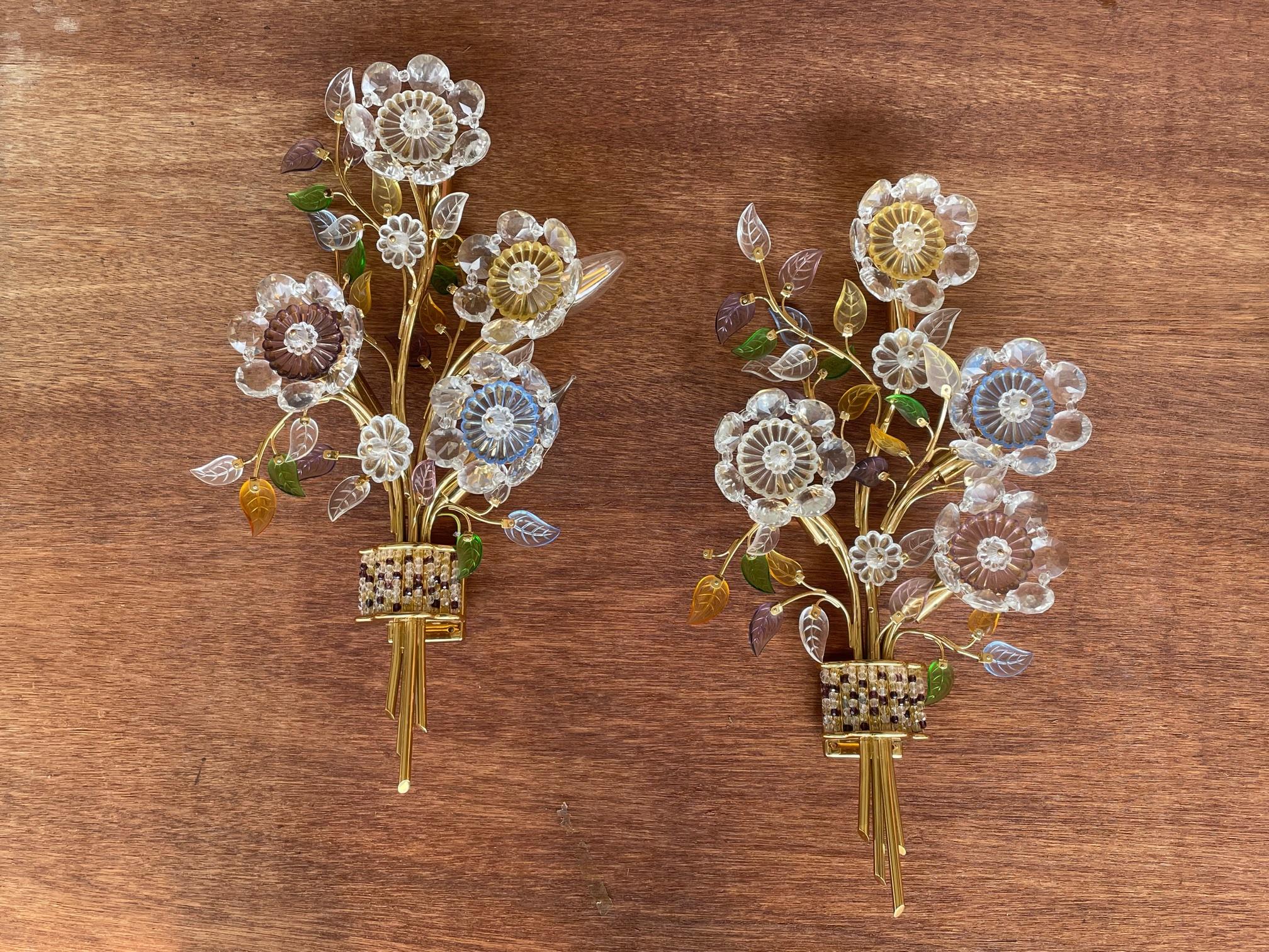 Fabulous pair of brass 4-light wall sconces feature cut glass flowers and leaves in a bouquet motif. Ready to be wall mounted and hard wired. Very good condition overall (see photos).
      