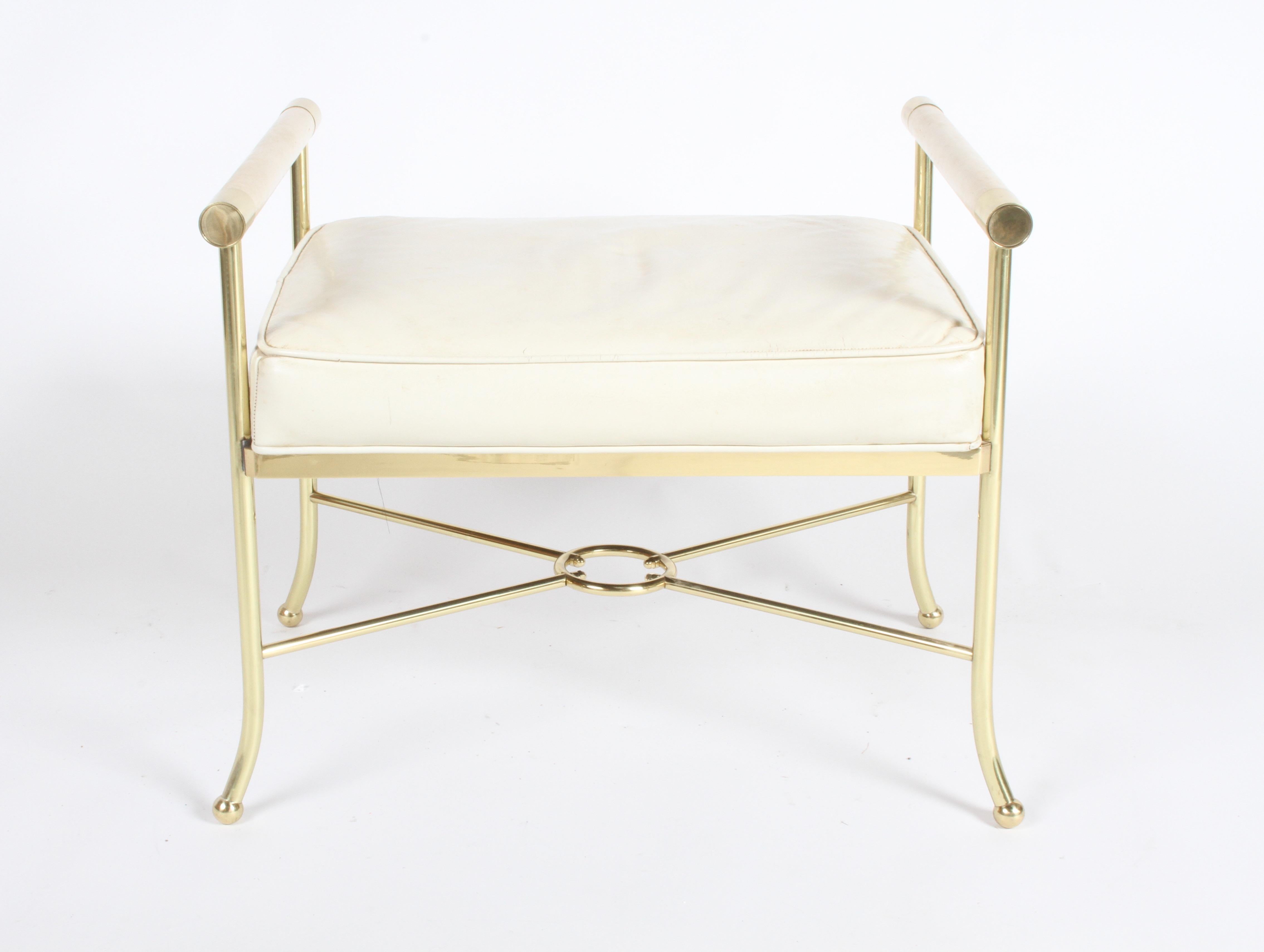 High Style Hollywood Regency brass and leather vanity bench or stool. Made of heavy brass, with original white leather seat and arms on splayed legs. Very well made, super high quality. From one owner estate, filled with MCM. Brass has been