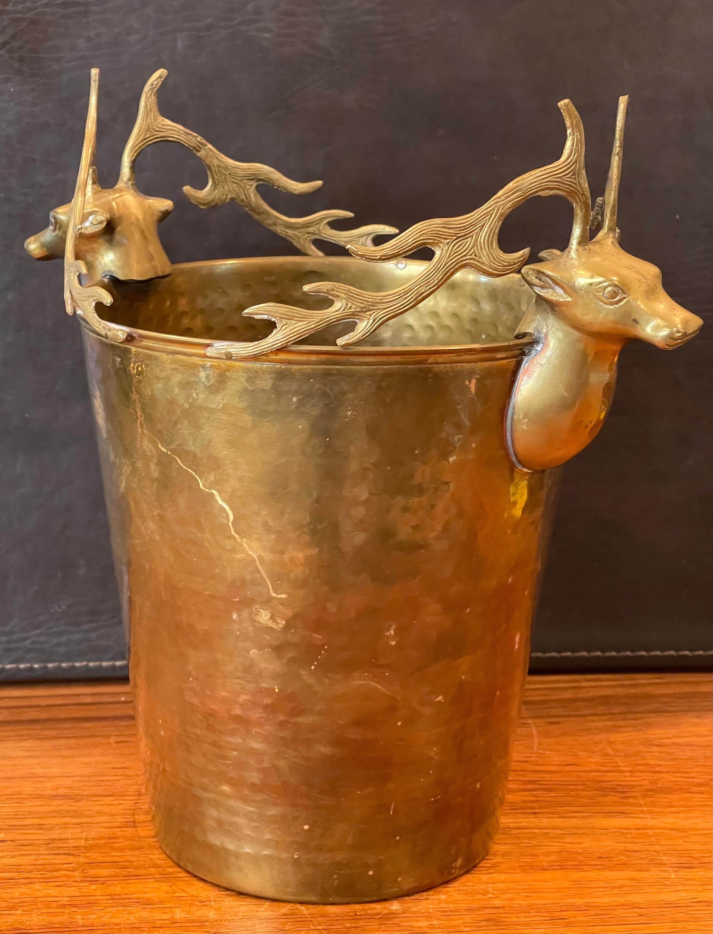 A stylish hollywood regency brass buck / deer ice bucket, circa 1970s. The bucket is in very good vintage condition with a nice patina and measures 11