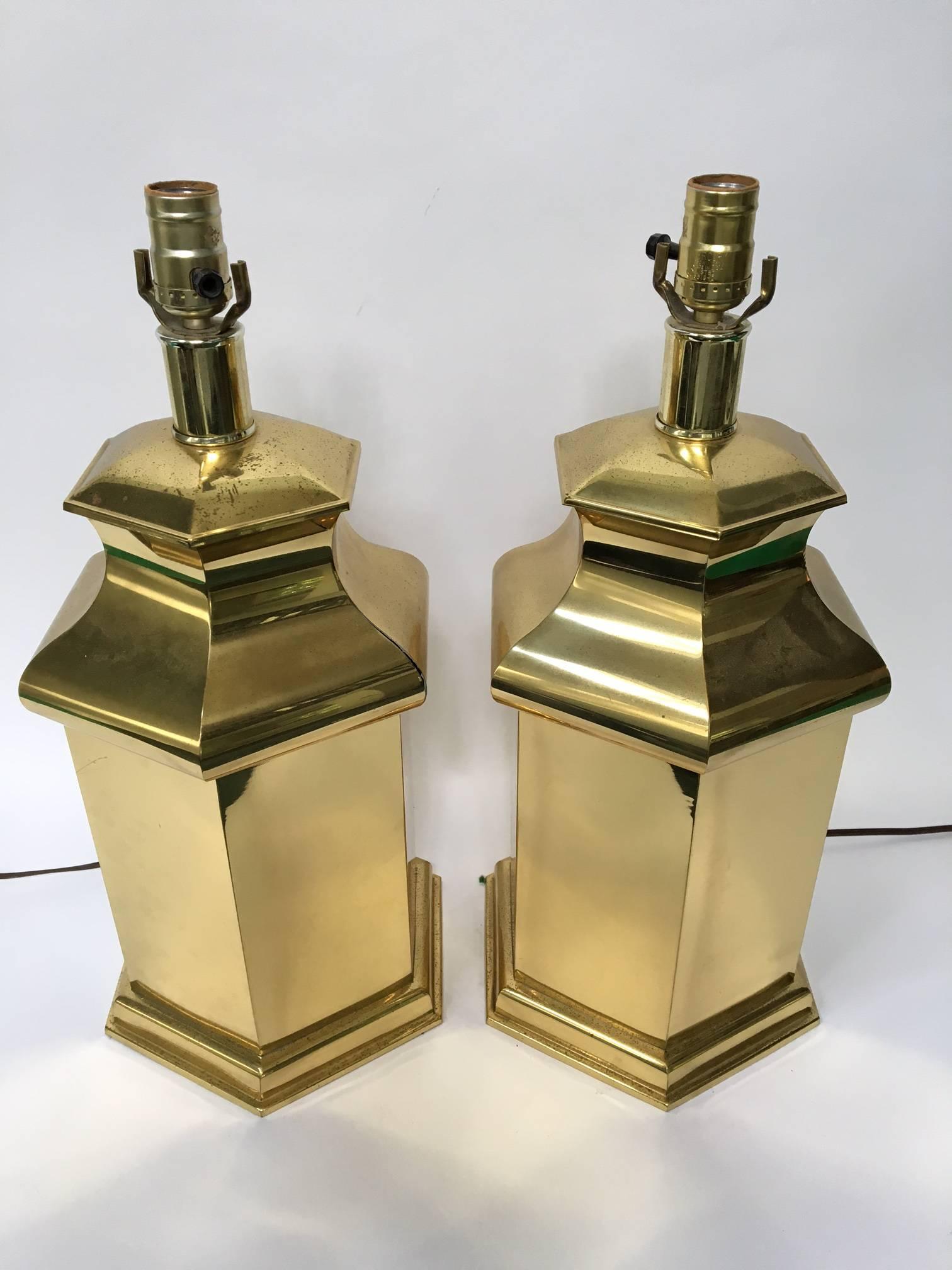 Pair of hexagon brass canister lamps ready to appear in your Hollywood Regency decor. Good vintage condition with slight tarnish.