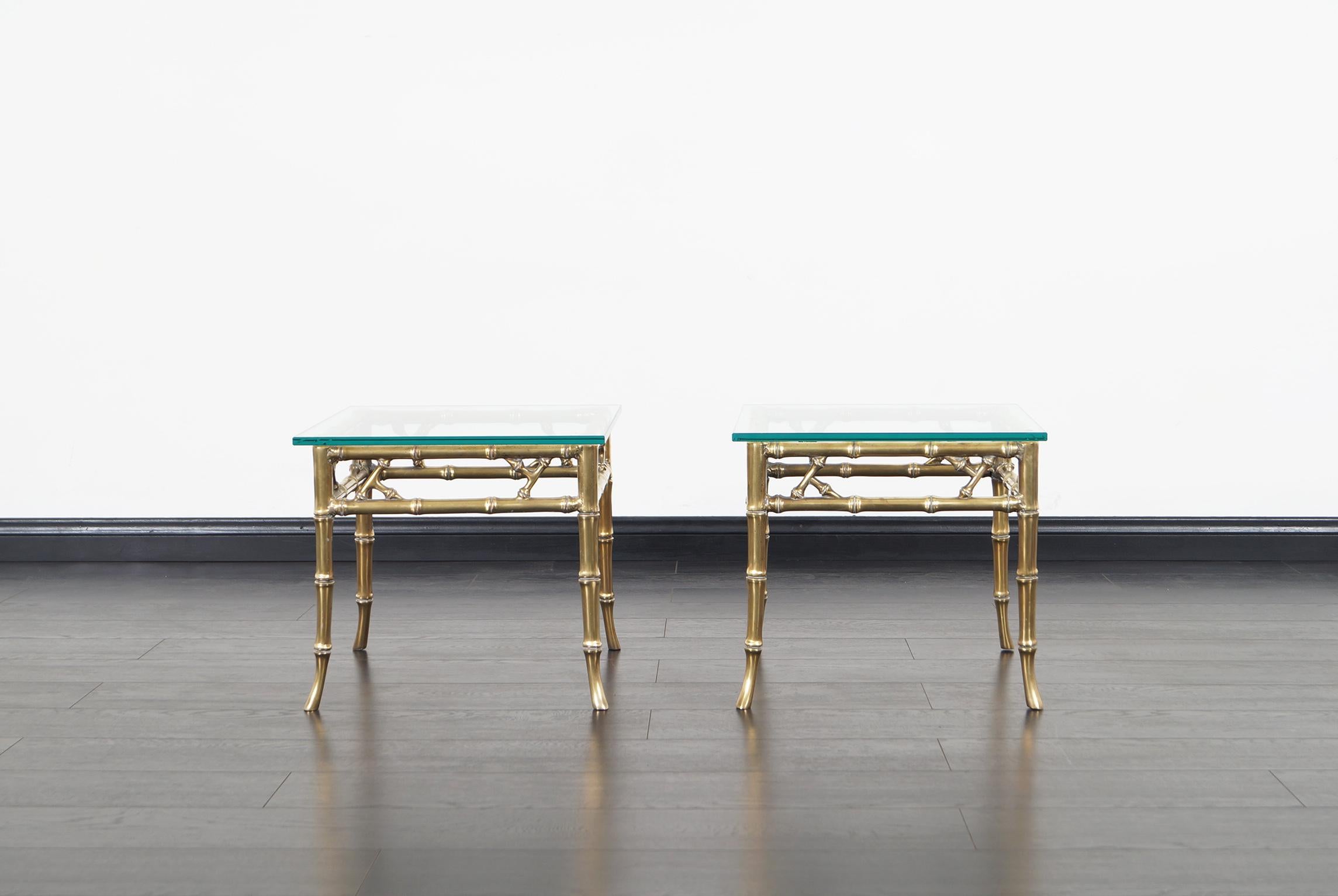 Gorgeous pair of Hollywood Regency faux bamboo side tables. Made of solid brass and glass top.