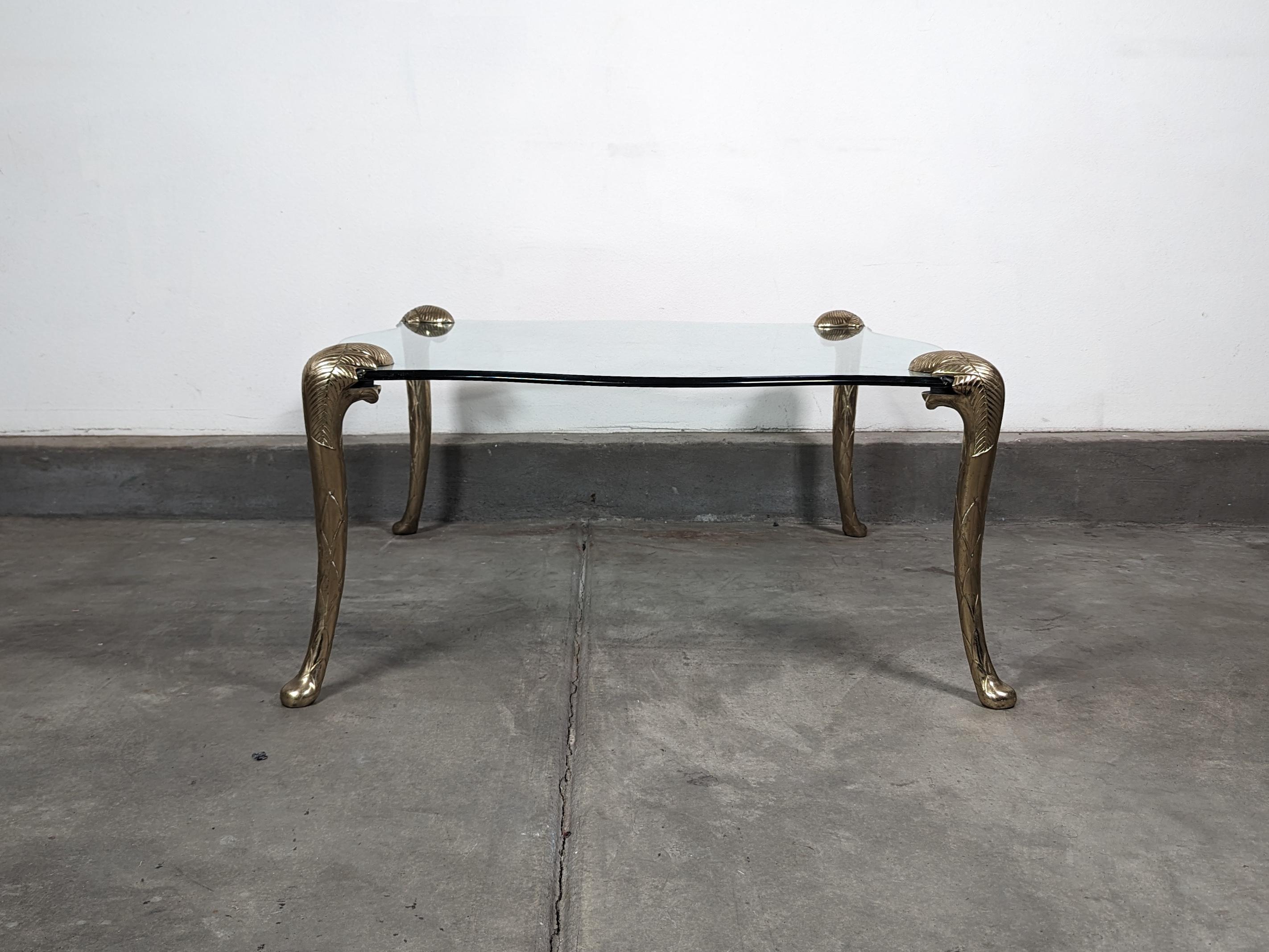 Step into the epitome of timeless glamour with this exquisite Hollywood Regency Brass and Glass Cocktail Coffee Table, in the manner of the esteemed P.E. Guerin. Crafted in the 1970s, this piece encapsulates the sophistication and opulence of an era