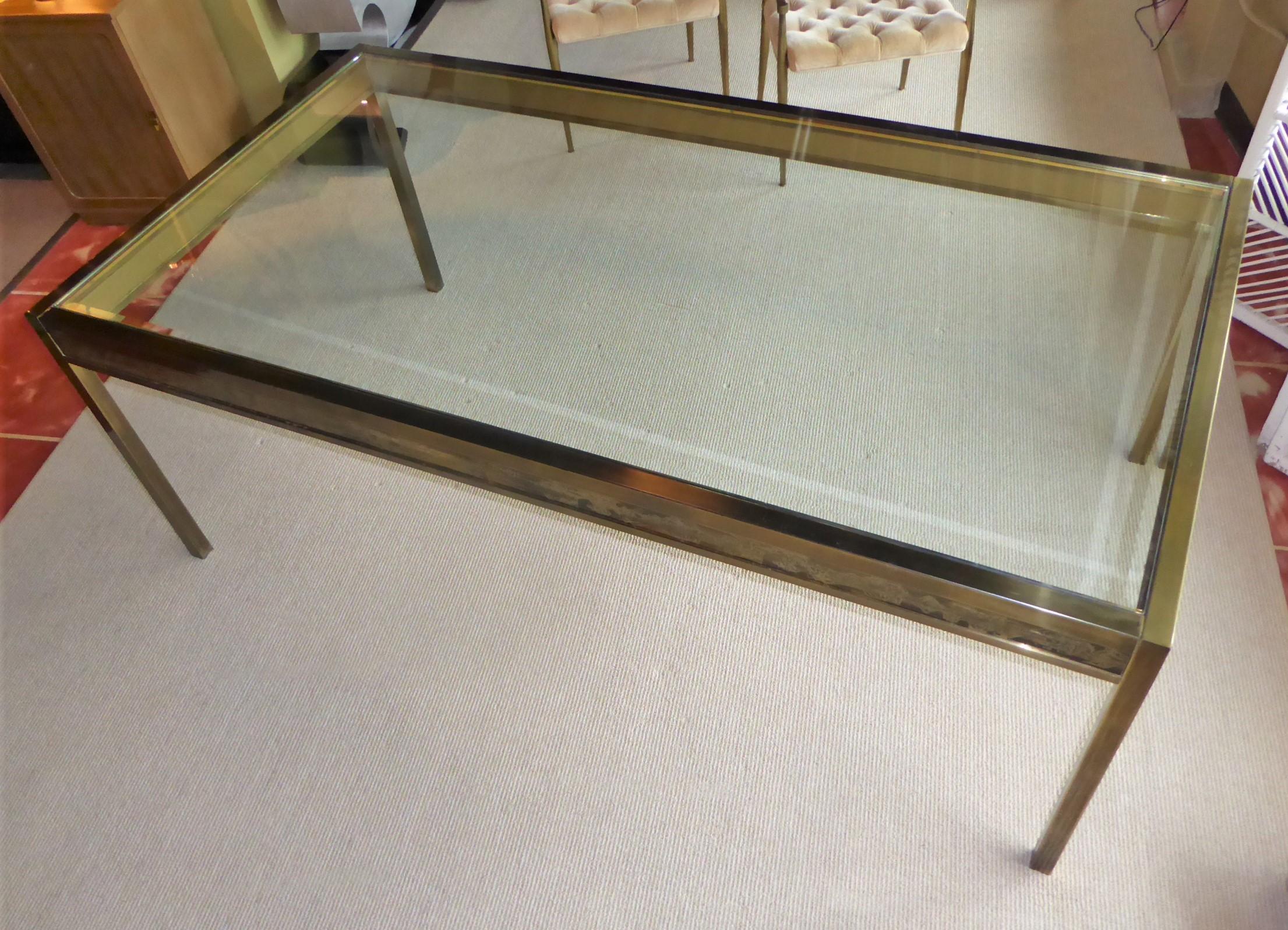 Large Mastercraft Brass and Glass Dining Table with panels by Bernhard Rohne.  Antique brass frame with acid etched decorated panels on its apron and an inset thick beveled glass top.  The brass is beautifully patinated although it has some age