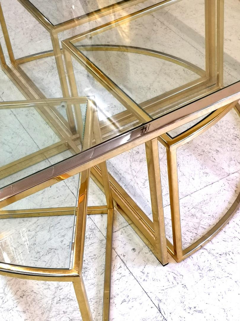 Four small movable tables which nest underneath the large table. Many different positions and design are available. Made of polished, brass plated steel.