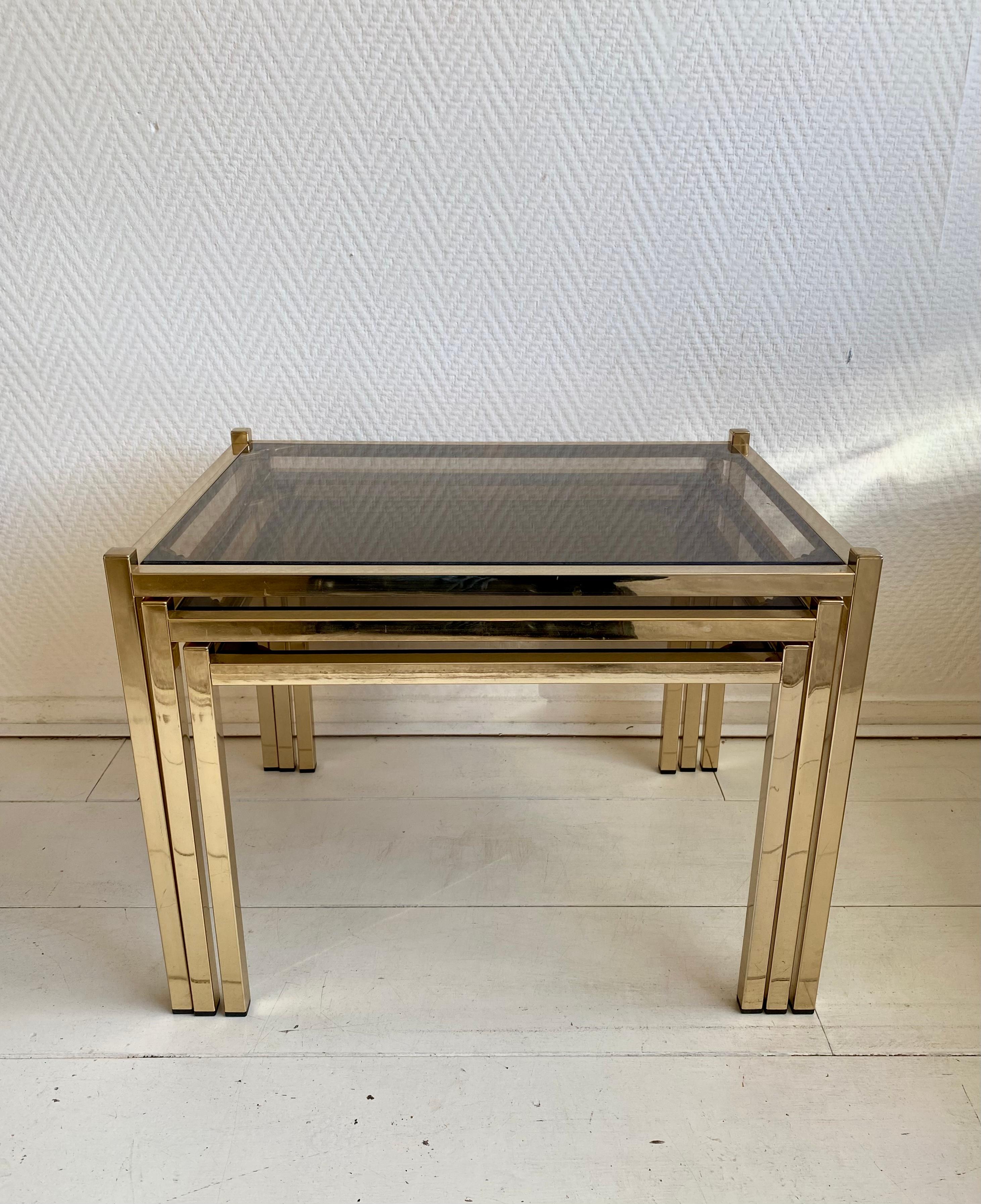 European Hollywood Regency Brass Nesting Tables With Smoked Glass For Sale