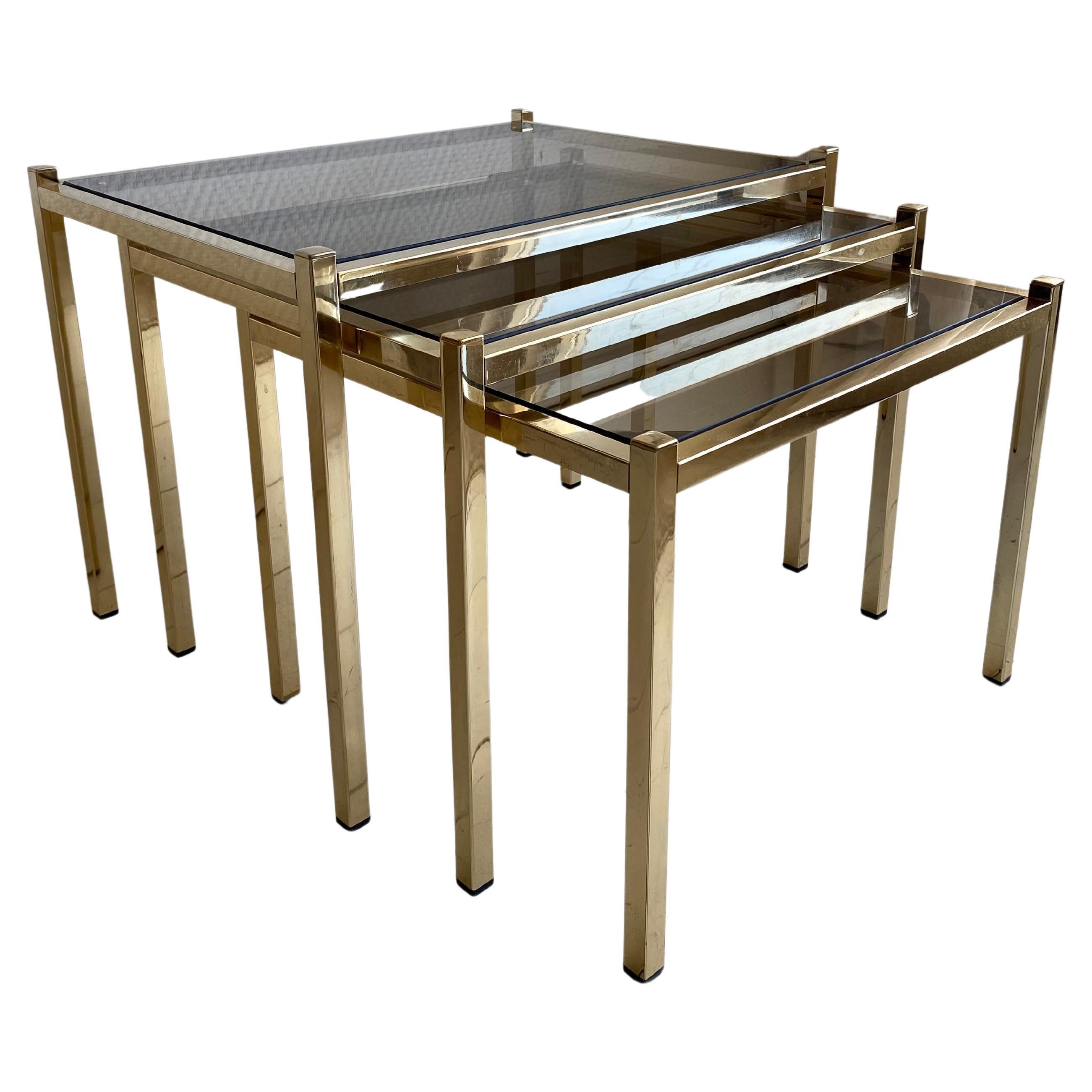 Hollywood Regency Brass Nesting Tables With Smoked Glass For Sale