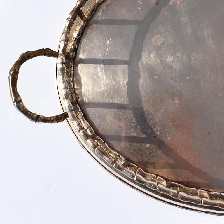 Lovely oval shaped metal faux bamboo tray. With a metal oblong base, the sides of this tray feature metal faux bamboo edges and handles. Made in India.

How We Would Style It:
We'd love to see this beautiful faux bamboo tray used to serve