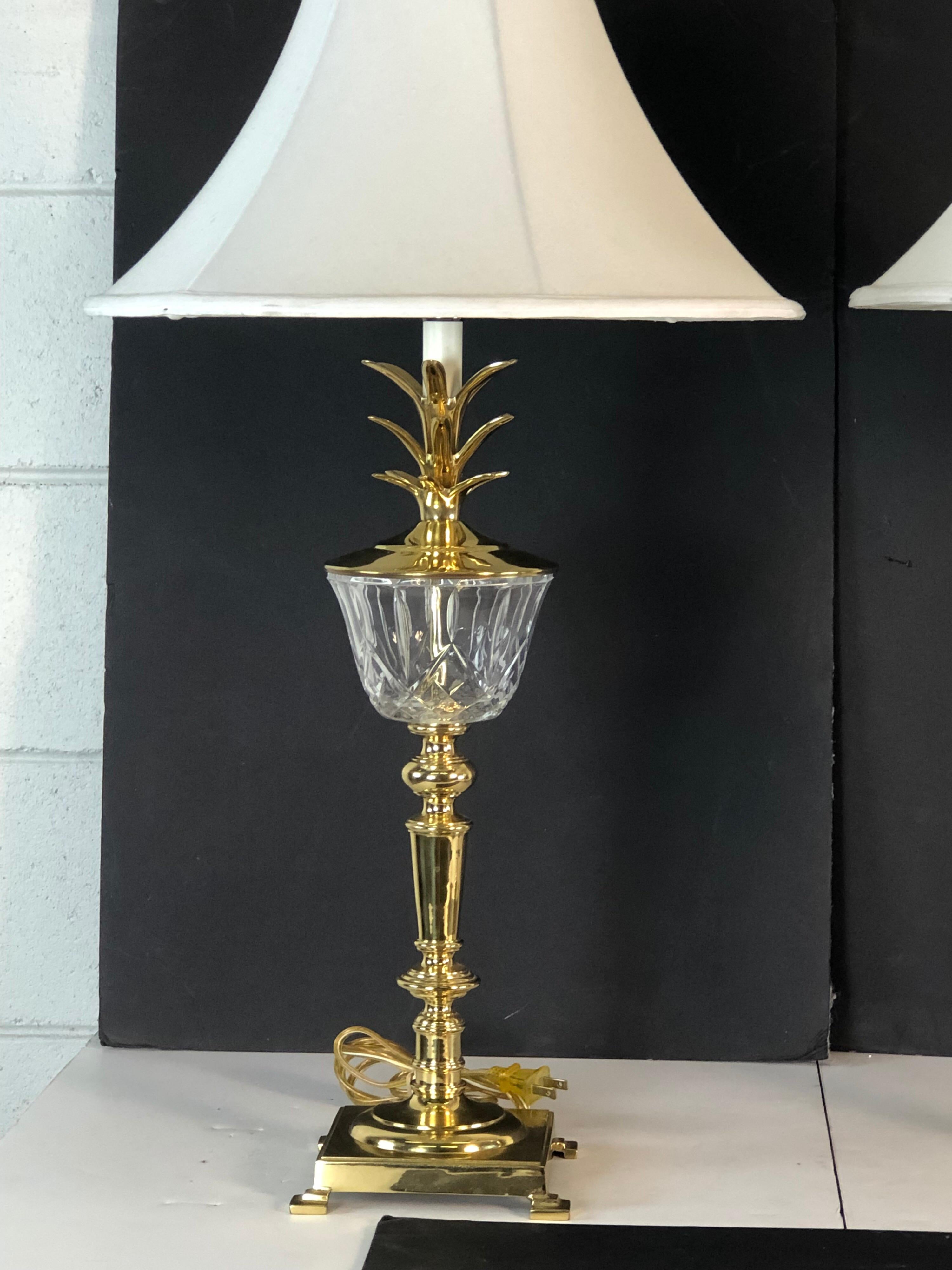 Hollywood Regency style pair of brass and glass pineapple table lamps. The lamps have the original brass finials. The lamps are wired for the US and in working condition. Socket, 23” height. Harp, 4”diameter x 9” height. The shades are not included.