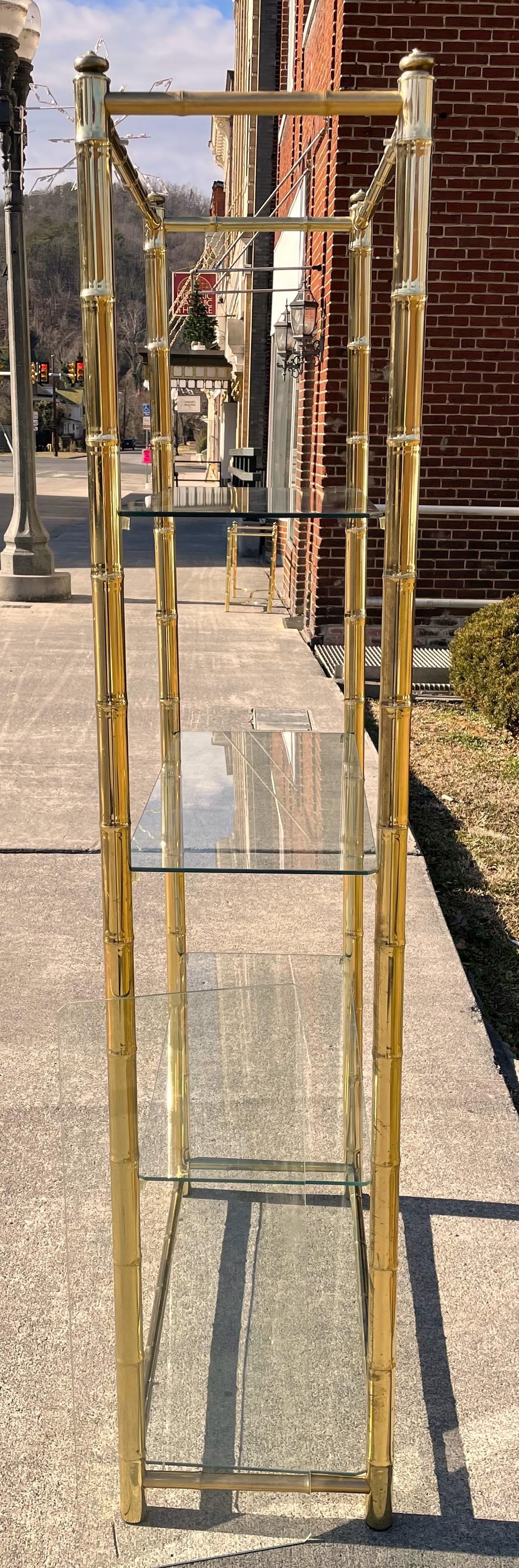 Here is a classy piece made of brass plated metal with 5 glass shelves. I have all the shelves including the top which I could not reach to put on safely for the photos. The metal has scratches, finish loss and signs of age and use (which I have