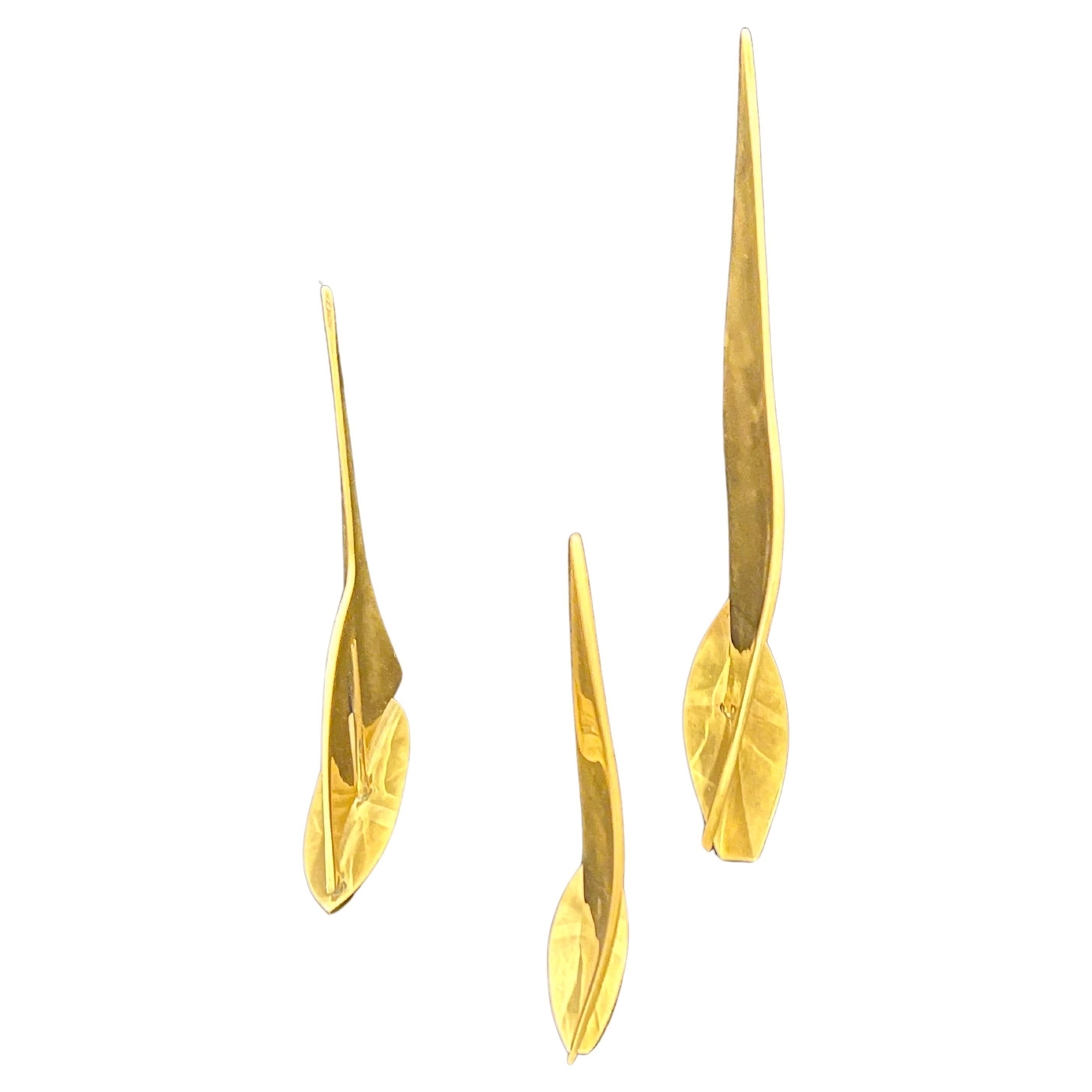 A whimsical set of 3 polished brass sailboats in 3 different sizes small to large, beautiful tabletop decorative sculptures.