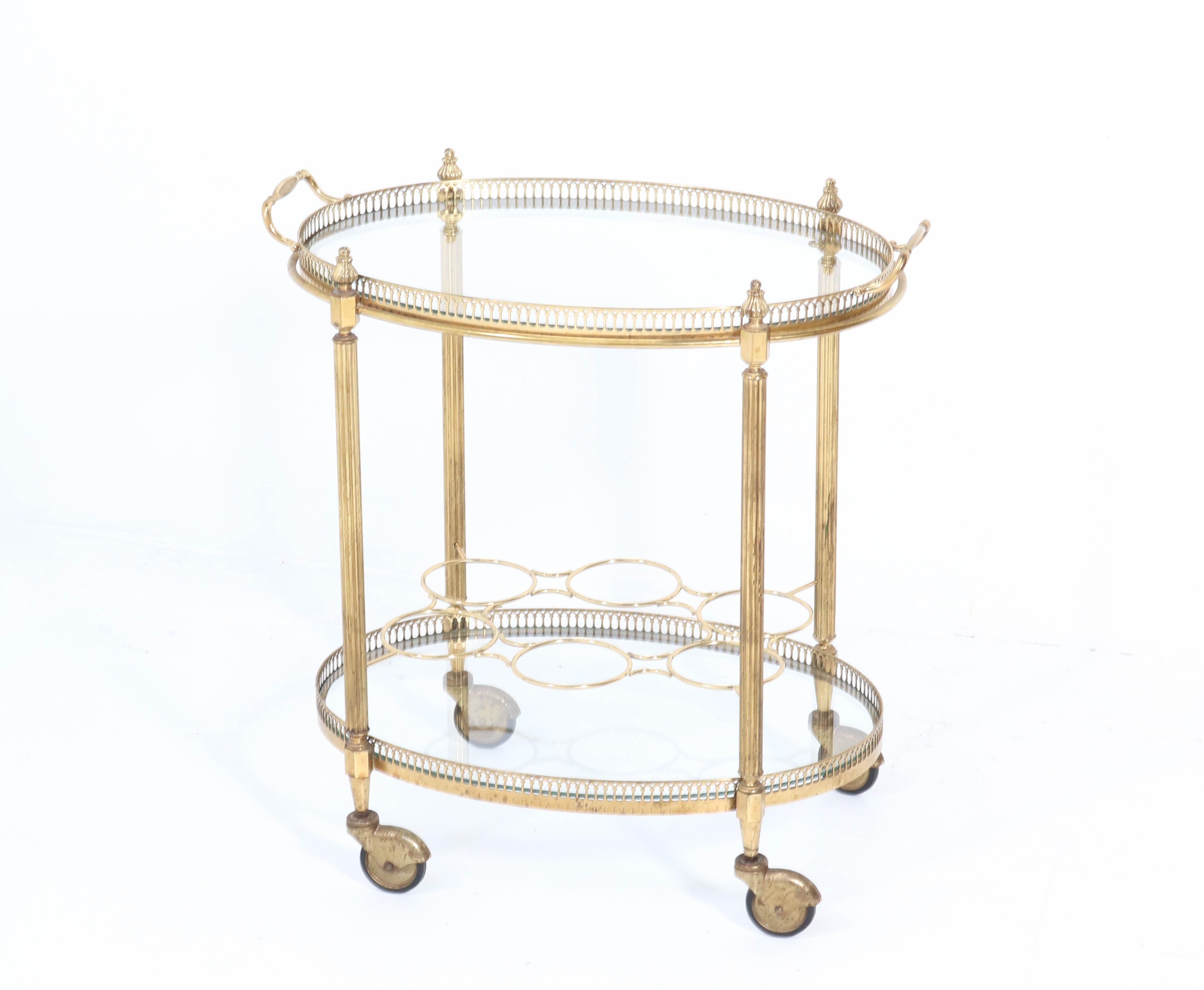 Stunning Hollywood Regency serving trolley.
Design attributed to Maison Jansen.
Striking French design from the 1950s.
Brass frame with original glass.
The top shelf can be used as a serving tray.
In good original condition with minor wear