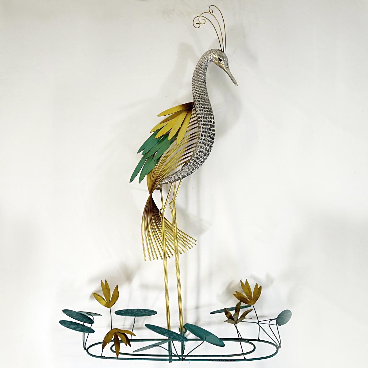 Gracious wall sculpture of a stylized silver heron or common crane designed by Curtis Jere and made by Artisan House. The object is made of brass with some patinated parts. 
Signed and dated 1987.