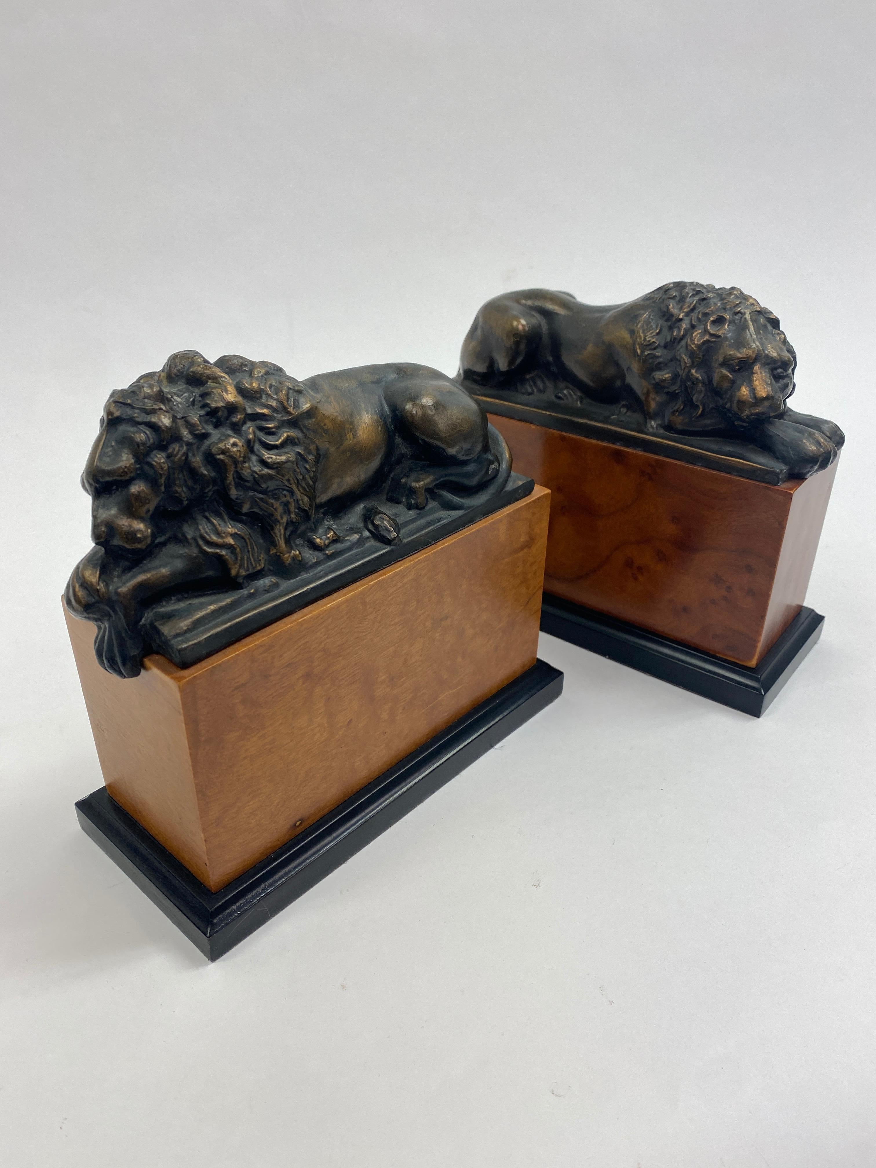 Handsome pair of bronze sleeping lion bookends. Both lions are resting atop of cherry wood blocks with an ebonized base lined with felt on the bottom surface.
Great items for a desk or bookcase.