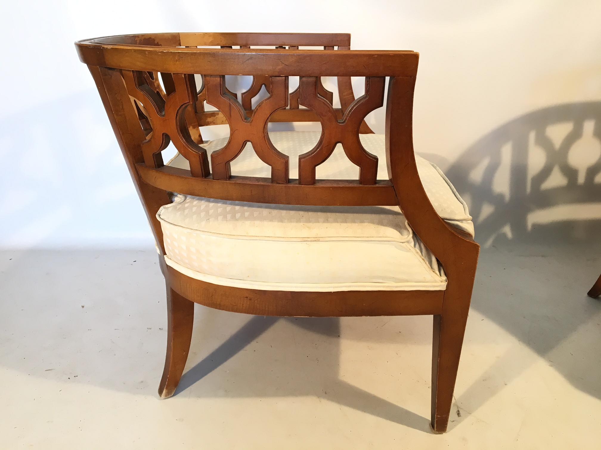 Pair of carved wood barrel back chairs in the manner of Dorothy Draper, perfect for your Hollywood Regency decor, circa 1968. Good vintage condition with some discoloration on finish. Structurally sound. Upholstery has no rips, holes, or odors, only
