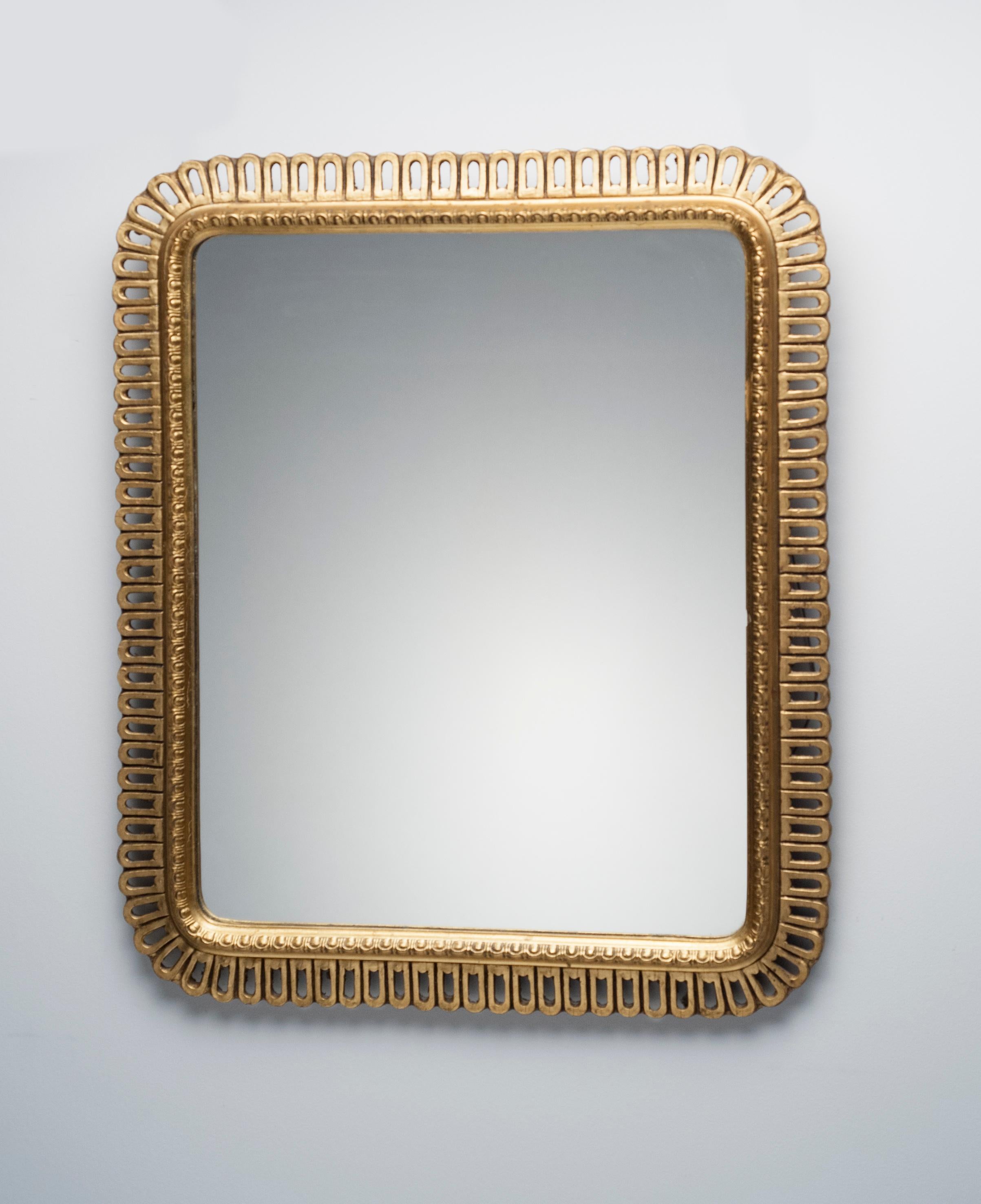 Beautifully made and appealing carved giltwood mirror. Mirror dates to the 1950s or possibly earlier. Mirror is wired to hang either vertically or horizontally.