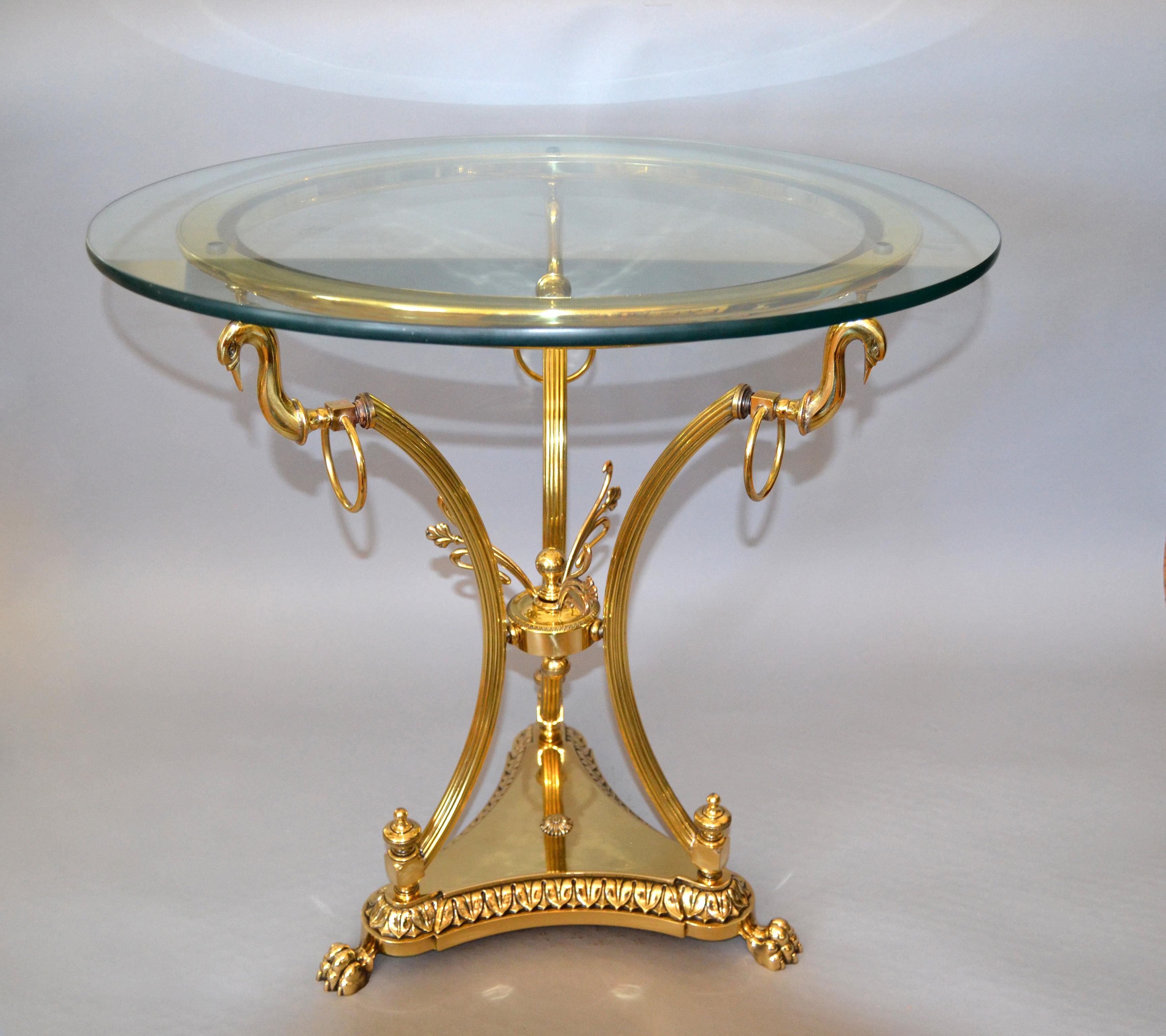 Hollywood Regency cast brass claw feet round glass side table.
Note the brass swans and other details on this side table.

Dimensions are without the glass top.

 