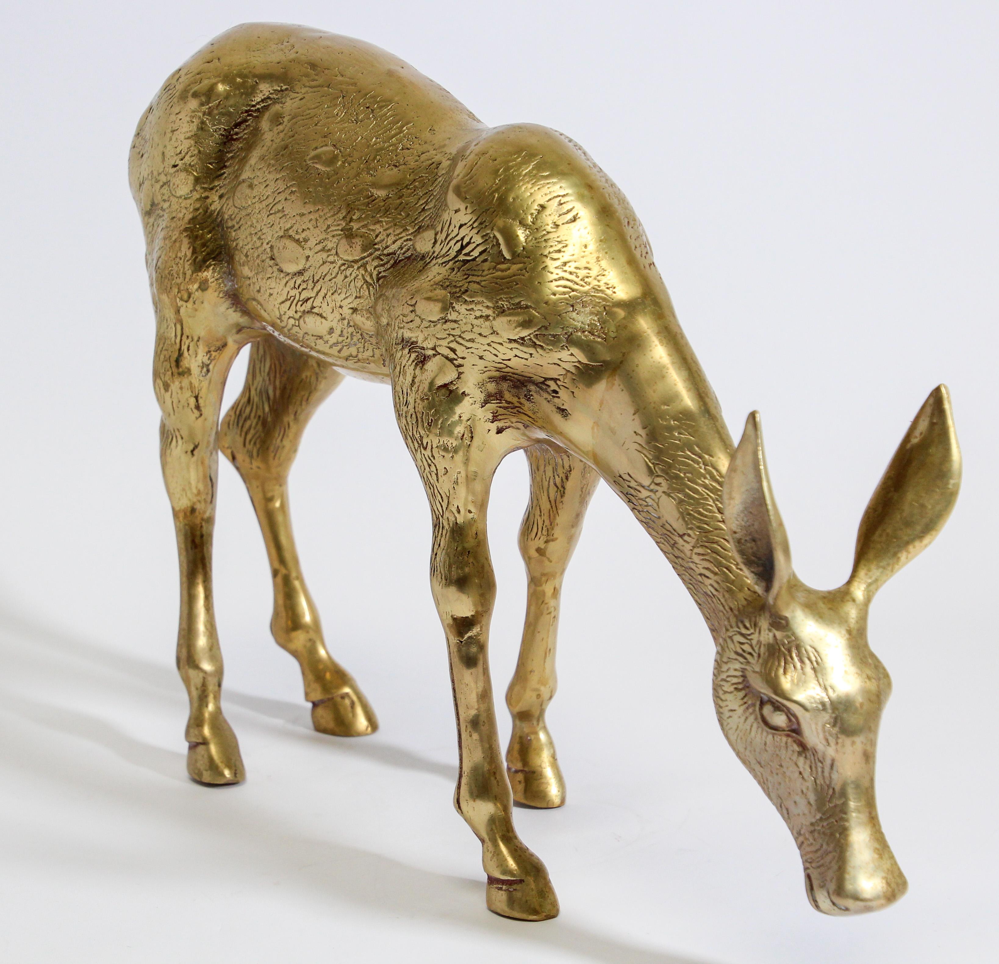 Gorgeous and substantial, striking iconic 1960s Hollywood Regency vintage Sarreid style cast brass standing doe sculpture. 
Large vintage midcentury solid hollow cast brass doe sculpture in great condition and Fine details. 
Floor sculpture, overall