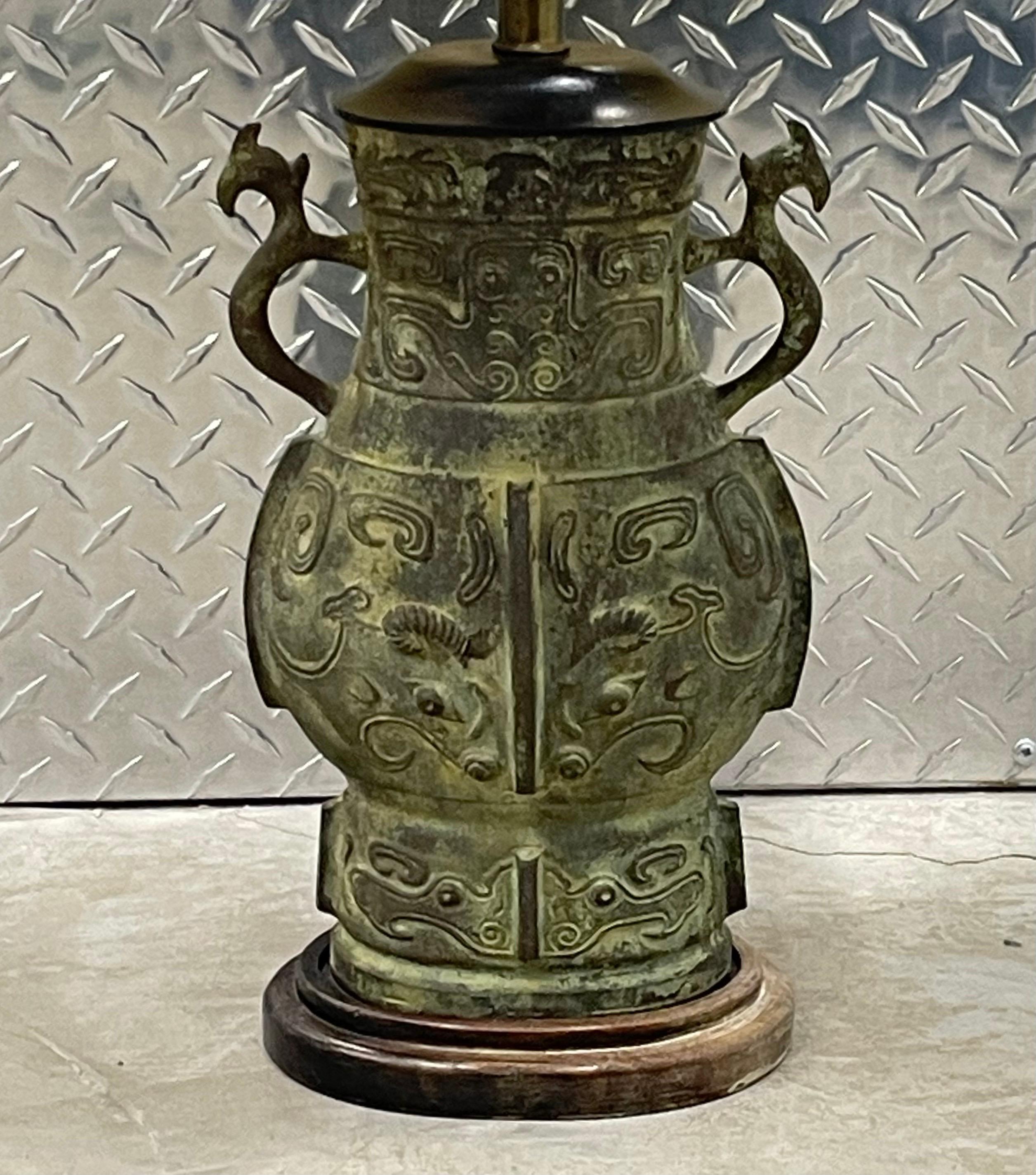 Hollywood Regency cast bronze table lamp in the style of James Mont.  Bronze height is 12