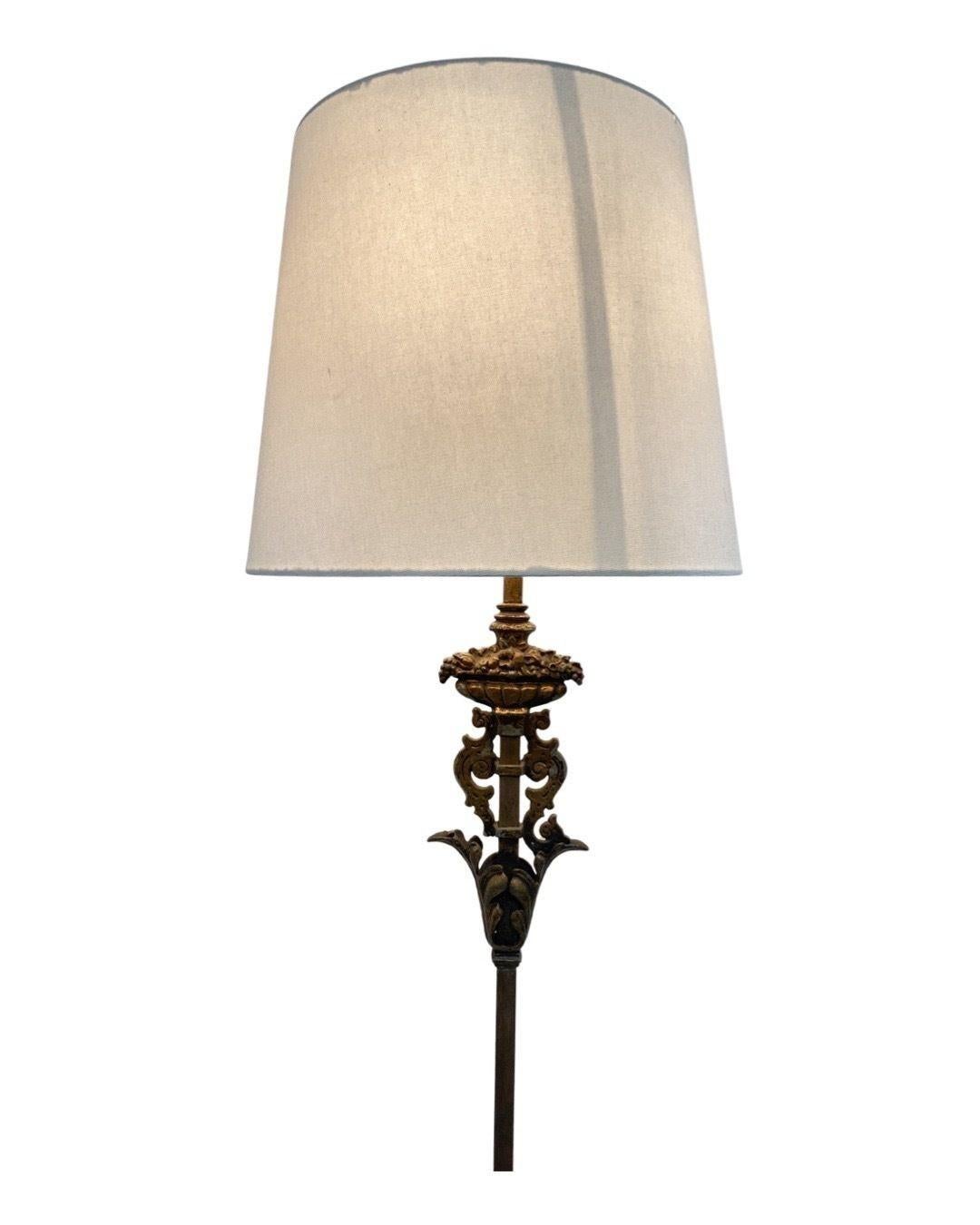 Rembrandt cast iron torchiere floor lamp with circular base and elegant floral wrought iron details.