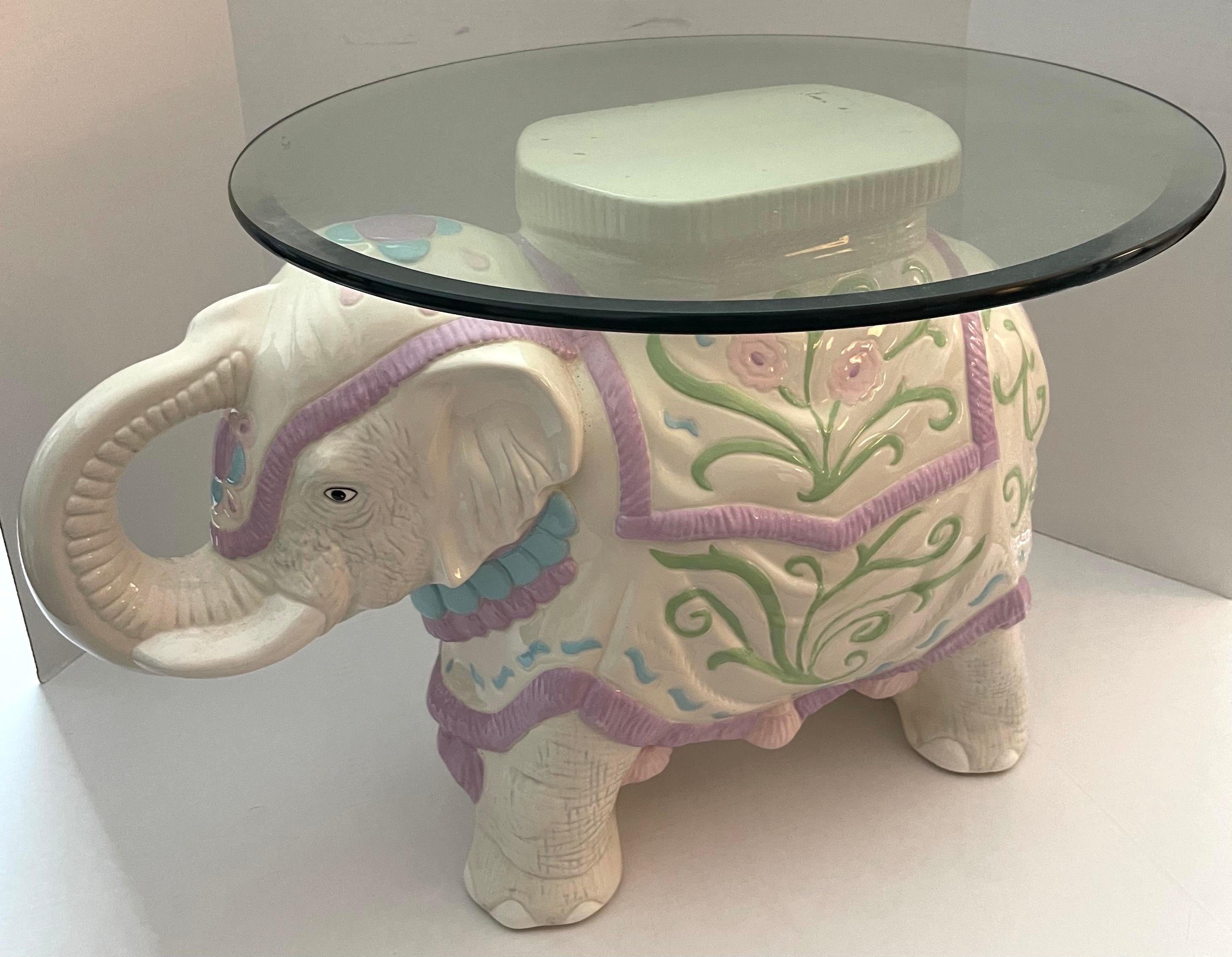 1960s Hollywood Regency style pastel colored ceramic elephant garden stool or side table. Round clear glass top with beveled edge.