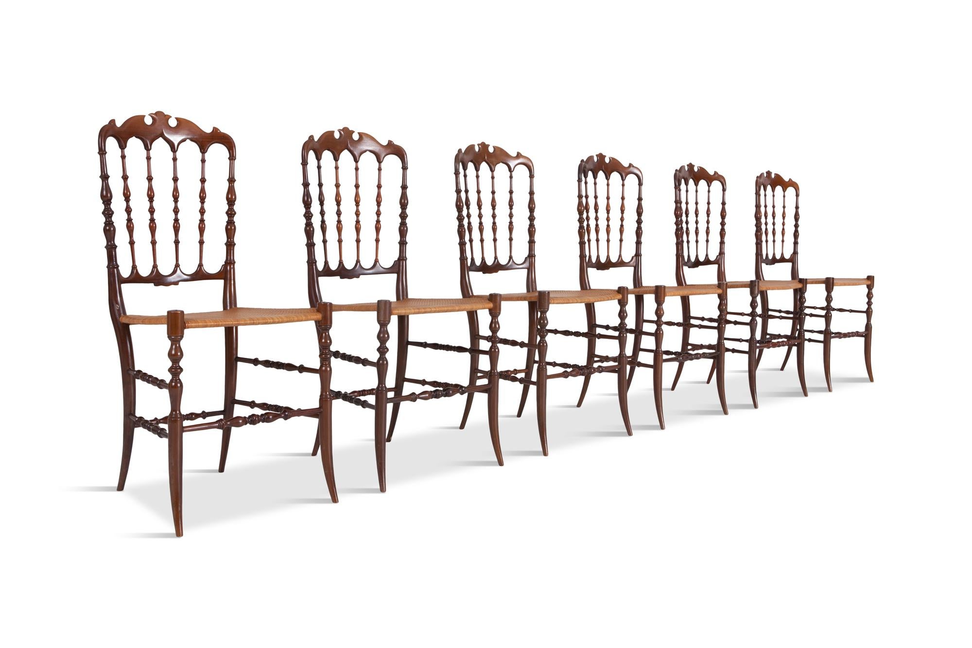 Cherrywood lightweight dining chairs, set of six. 

Provided with a beautiful crest rail, spindled back and woven wicker seats. The front legs continue the spindled technique. This Chiavari chair was originally designed by Giuseppe Gaetano