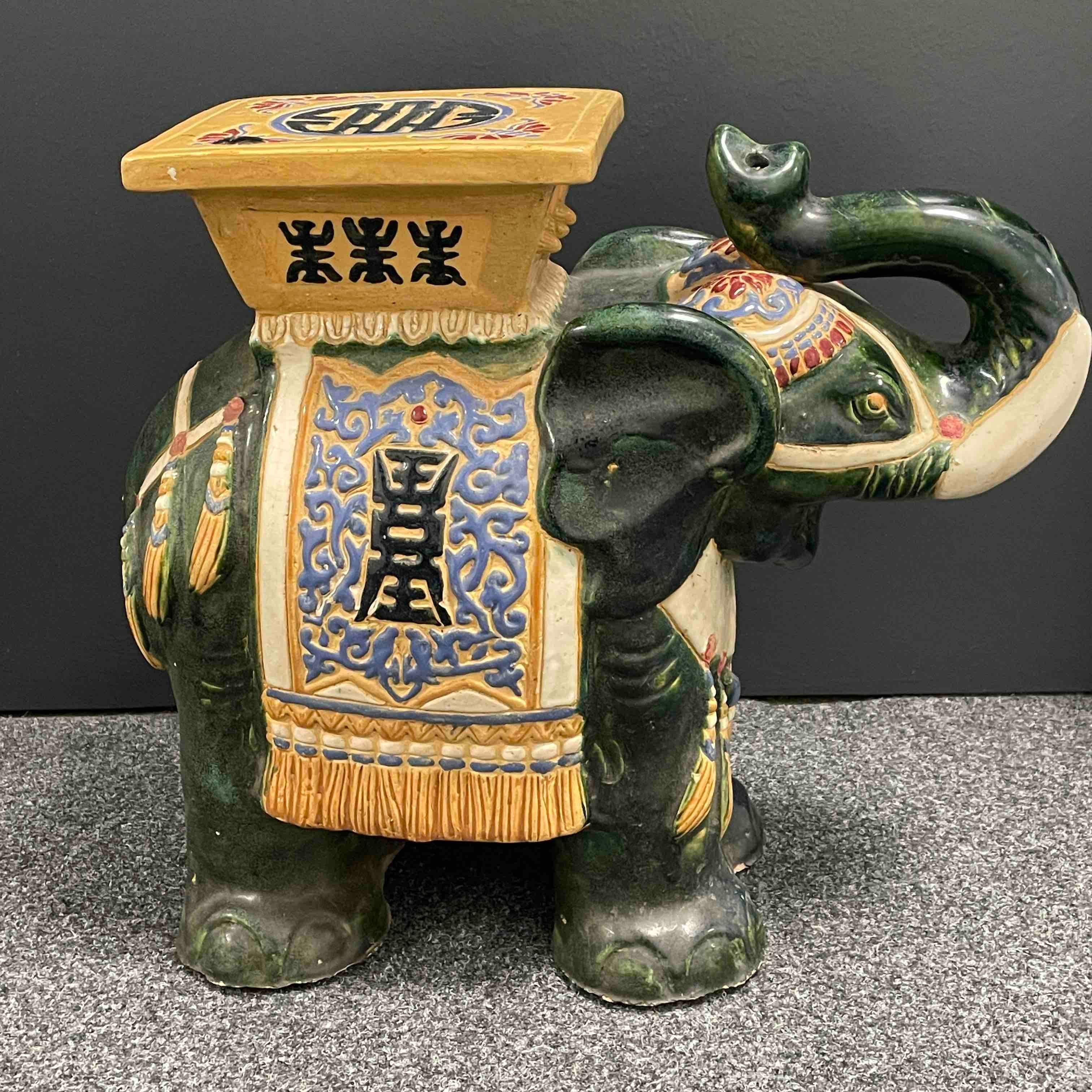 green ceramic elephant plant stand