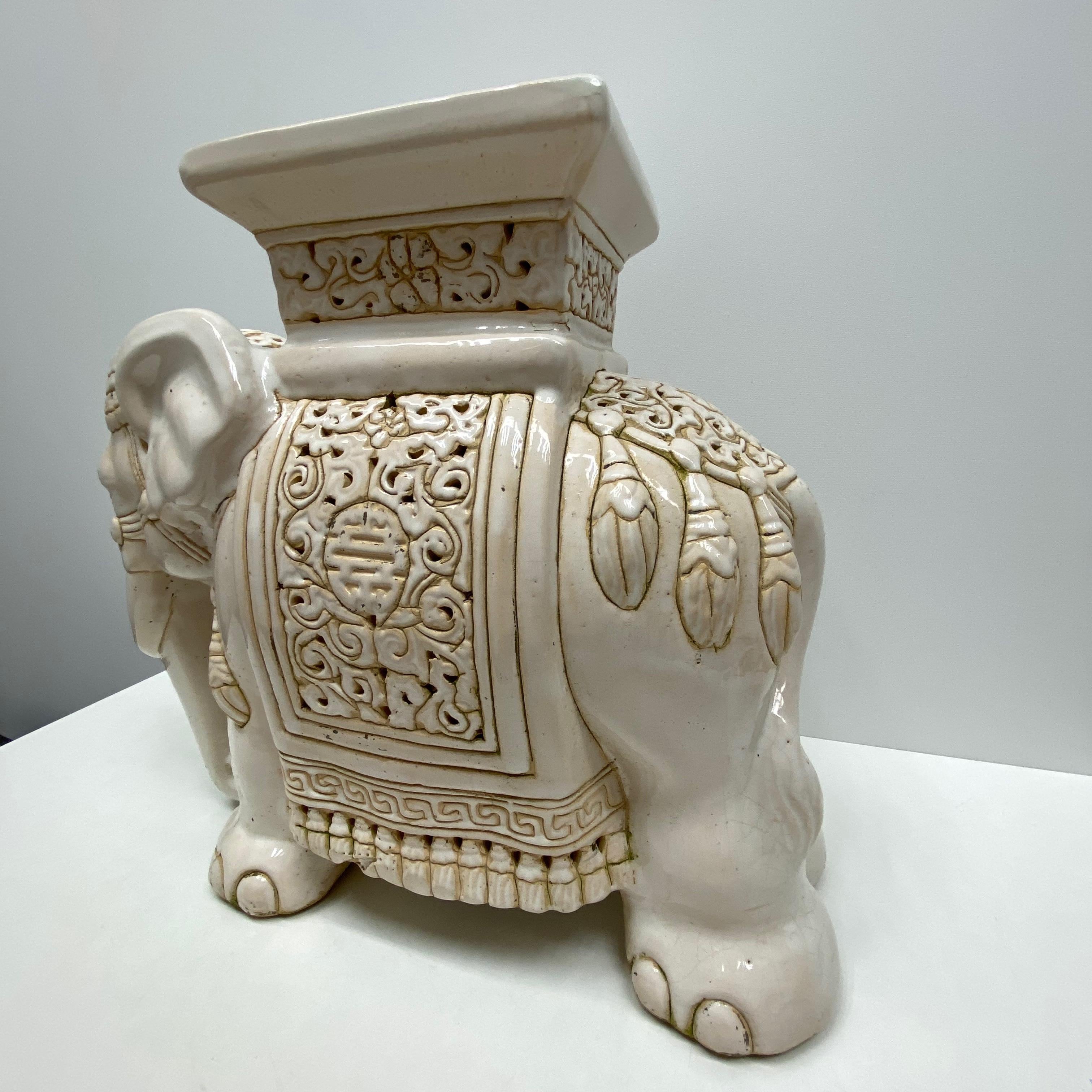 white ceramic elephant plant stand