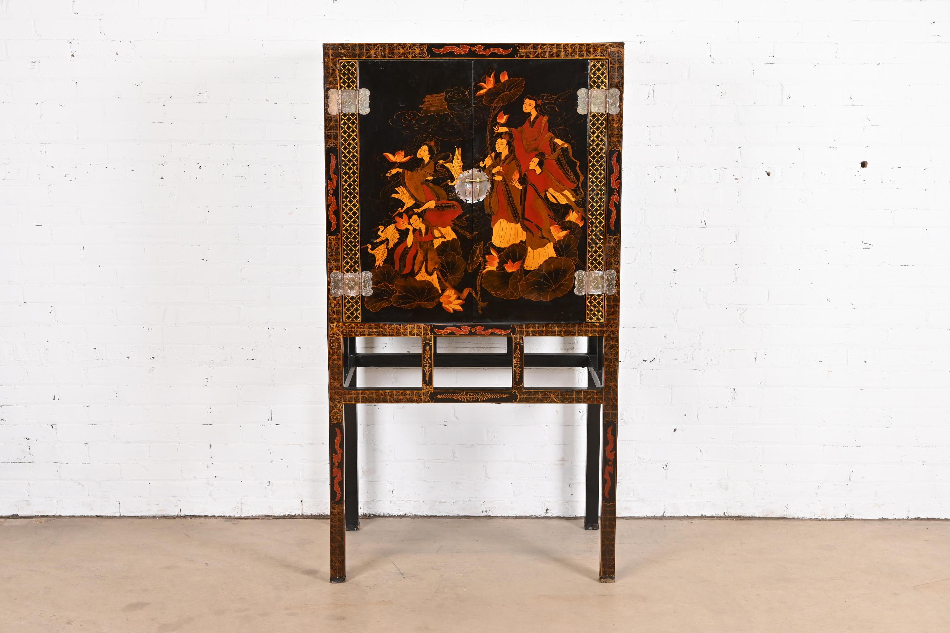 A gorgeous mid-century Hollywood Regency Chinoiserie style media cabinet or bar cabinet

Circa Mid-20th Century

Black lacquered case, with hand painted Asian scenes, and original brass hardware.

Measures: 34