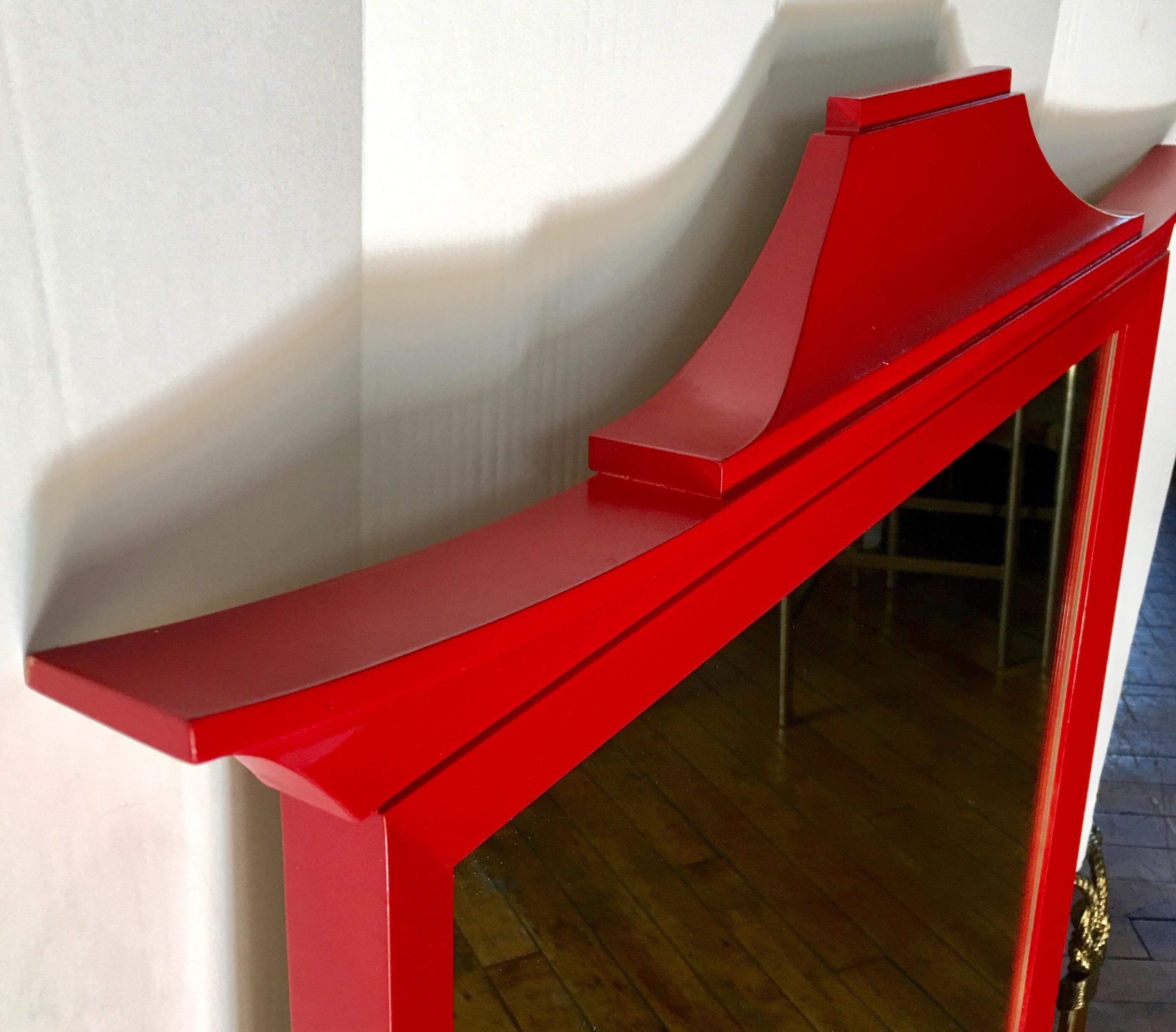 Midcentury Asian style pagoda wall mirror. Red gloss lacquer painted finish. In the style of Tony Duquette.