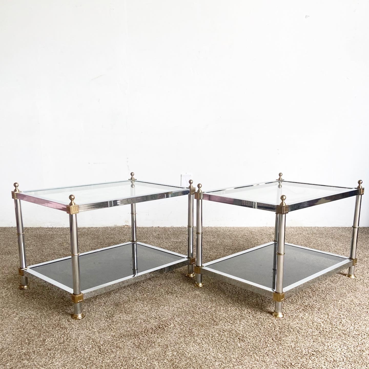 Embrace timeless glamour with our Hollywood Regency Chrome and Gold Smoked Glass Side Tables. Featuring a dual-tier design with chrome and gold accents, these tables offer elegance and drama. The clear and smoked glass surfaces provide ample display