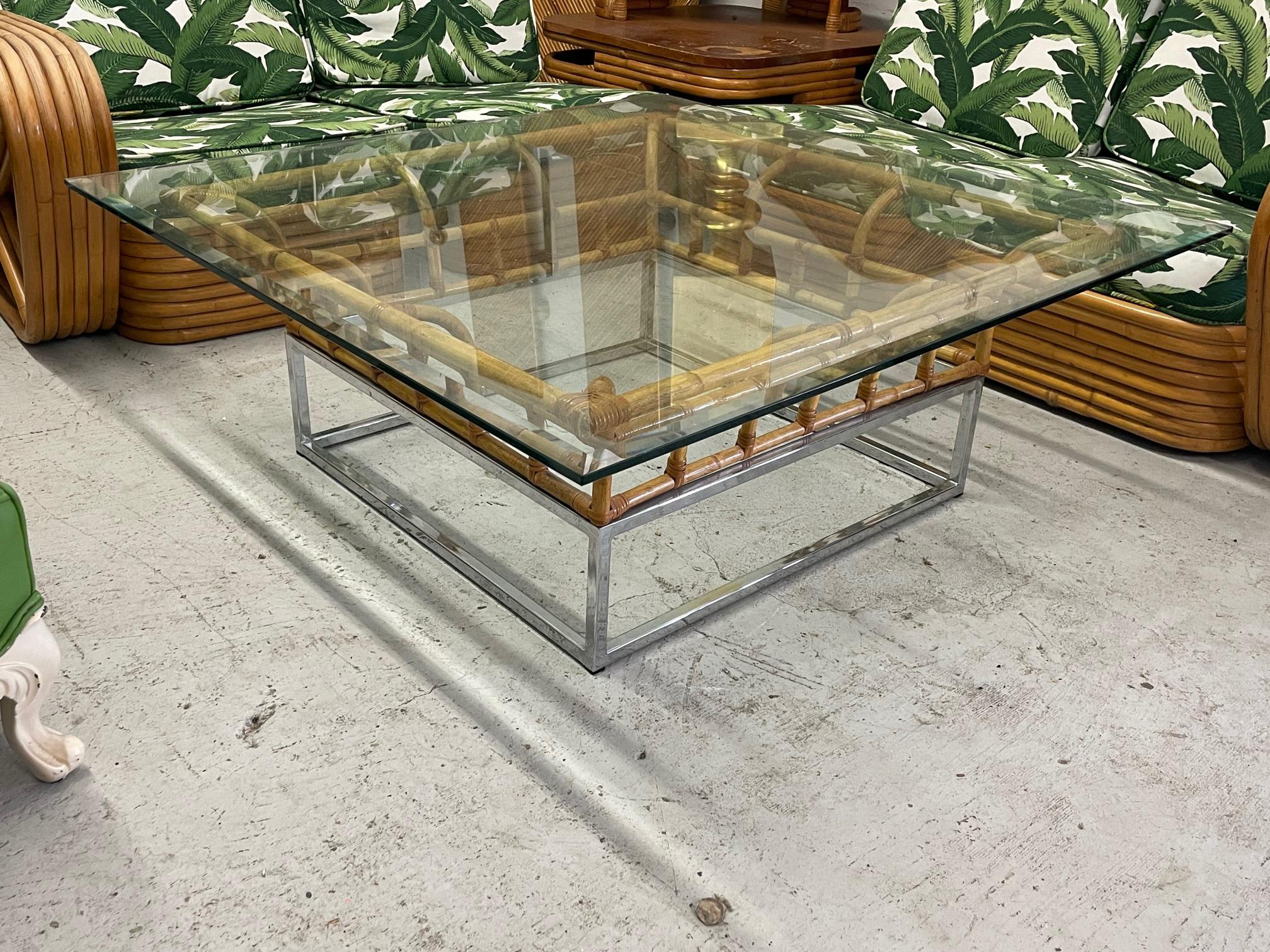 Chrome and rattan coffee table features a perfect blend of mixed media. Splayed rattan mounted atop a square chrome frame. Glass top with beveled edge.
Glass measures 43.5