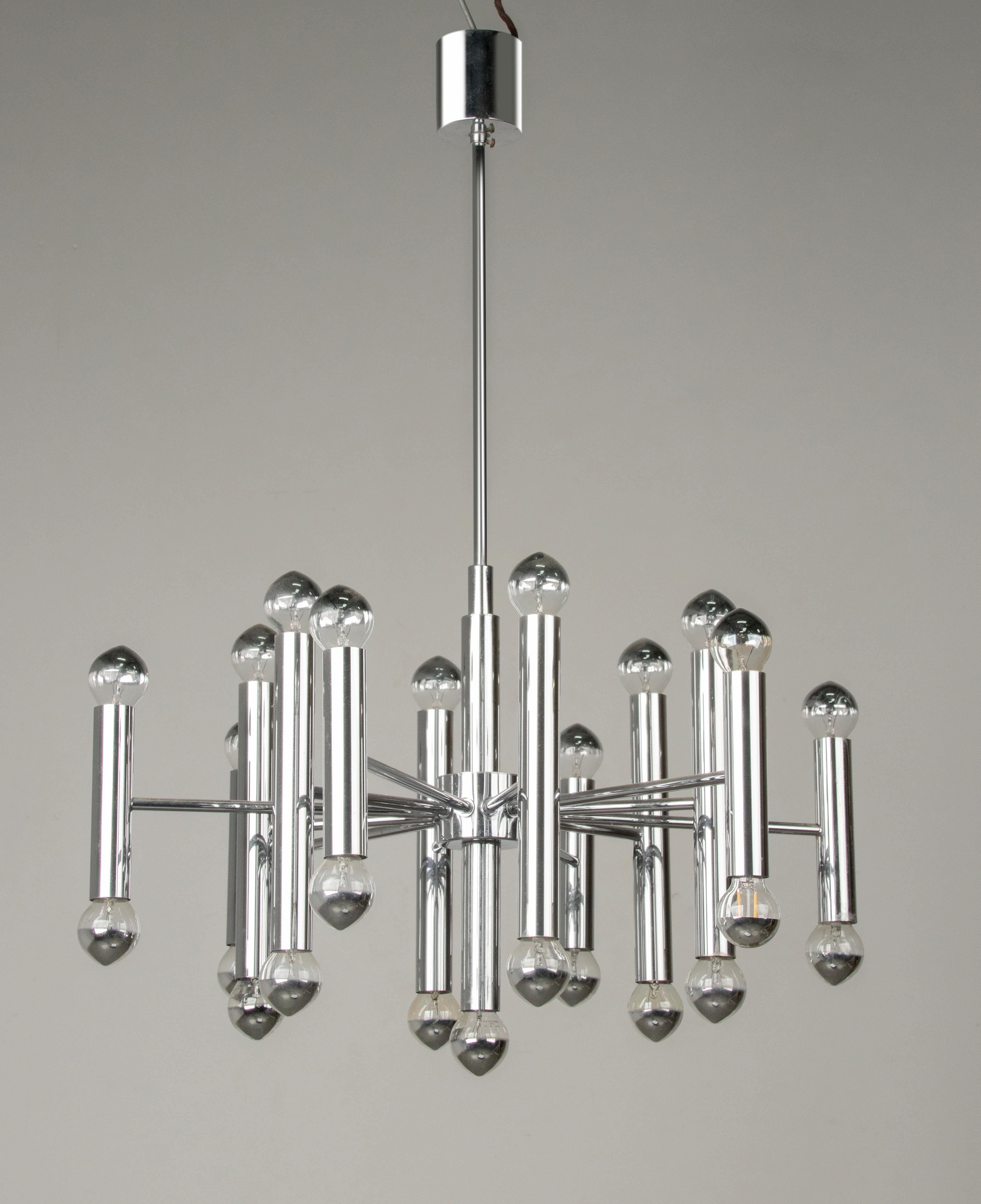 A styish mid-century tubular chandelier, designed by Gaetano Sciolari. The lamp is made of chrome plated metal. It has 12 arms, on each arm two lights, in total 24 lights.
The chandelier is fully working, suitable for 220-240 V. The chrome plating