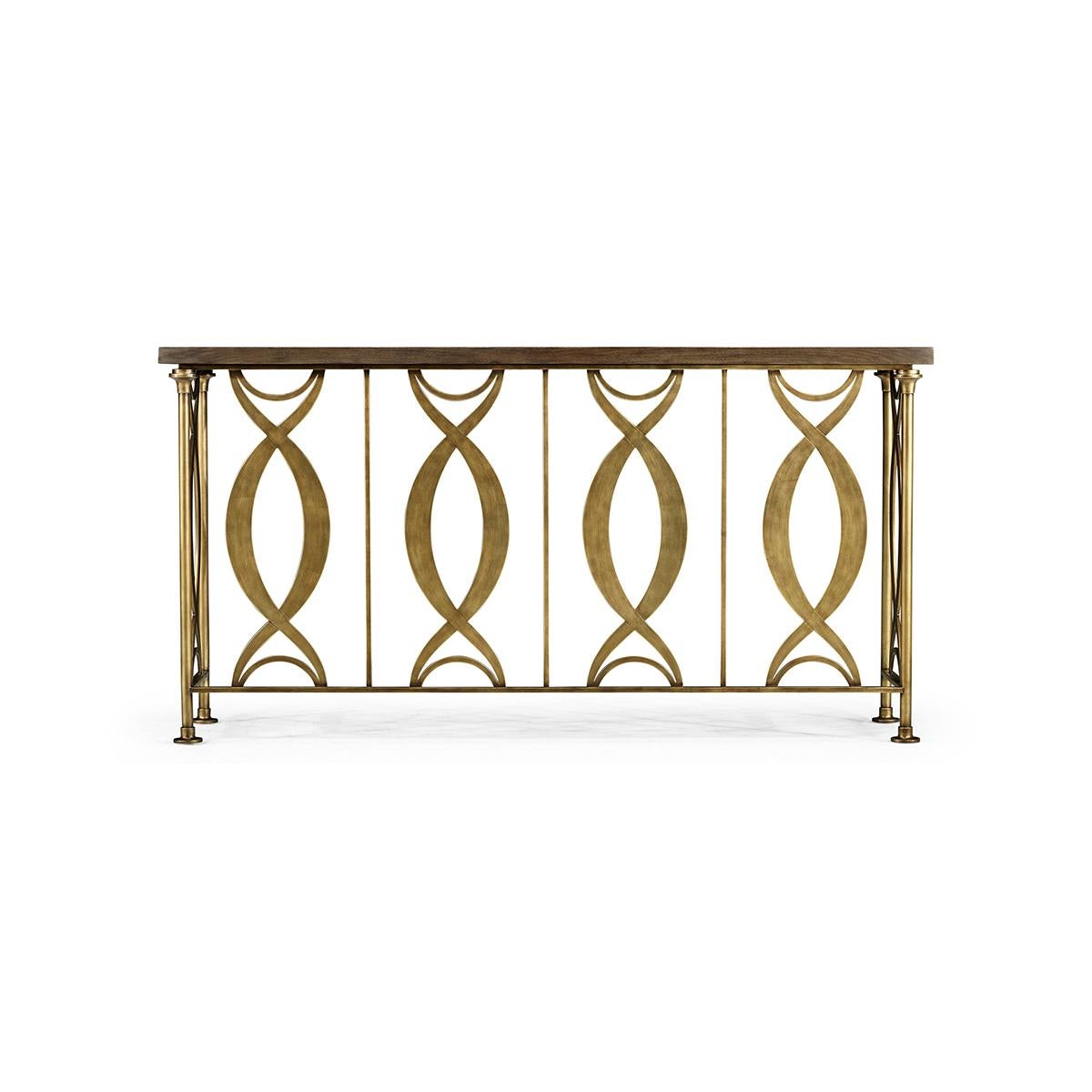 Introducing the Hollywood Regency console table, a stunning masterpiece that captures the essence of luxurious living. This table is crafted from brass with an antiqued gold leaf finish that elevates its glamour quotient. The top features a stunning