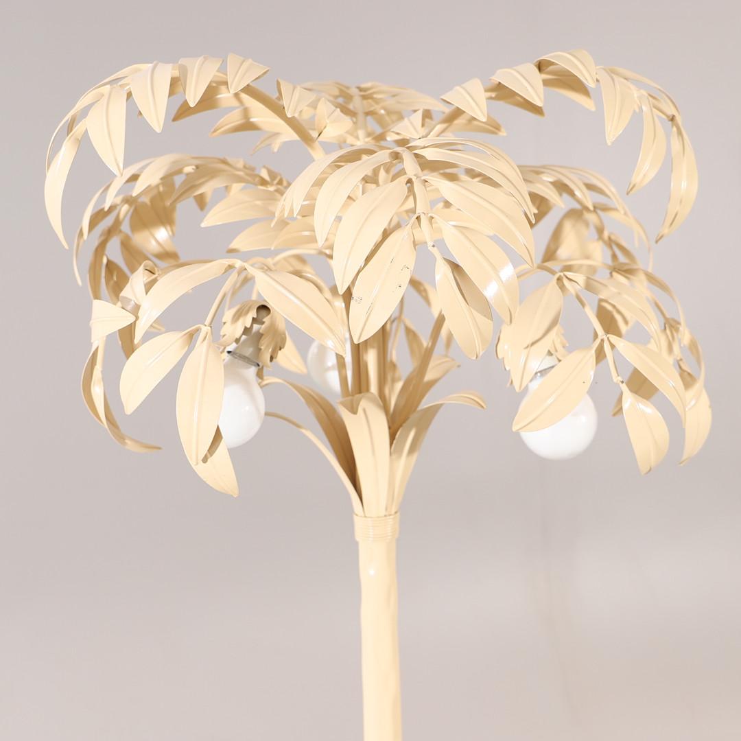 Introducing the cream white palm tree floor lamp, a stunning piece that beautifully captures the essence of Hollywood Regency. With its timeless design and impeccable craftsmanship, this lamp is sure to add a touch of vintage elegance to any space.