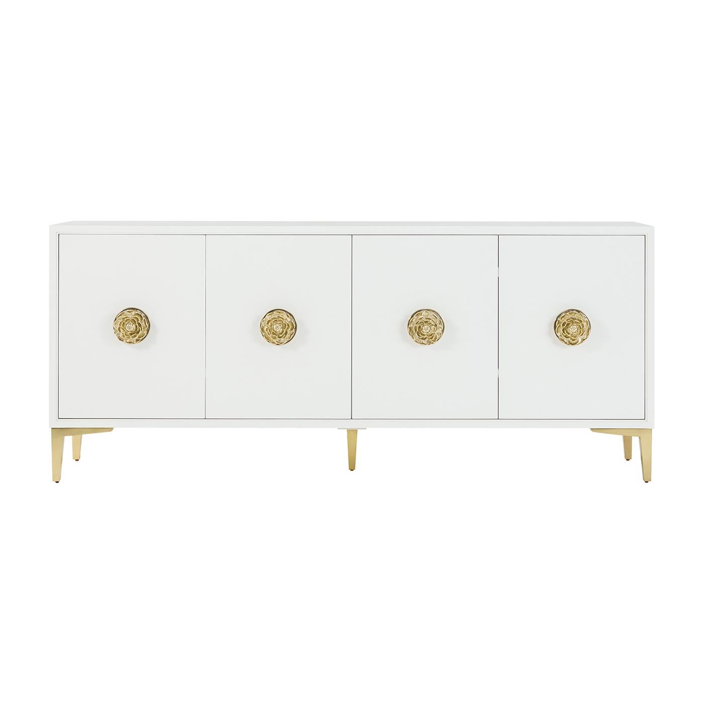A standout piece that brings bold sophistication to any space. Crafted from wood and finished in a sleek white lacquer, it features four doors adorned with oversized polished brass rose knobs, each backed by a luminous pearlescent plate.

Tapered