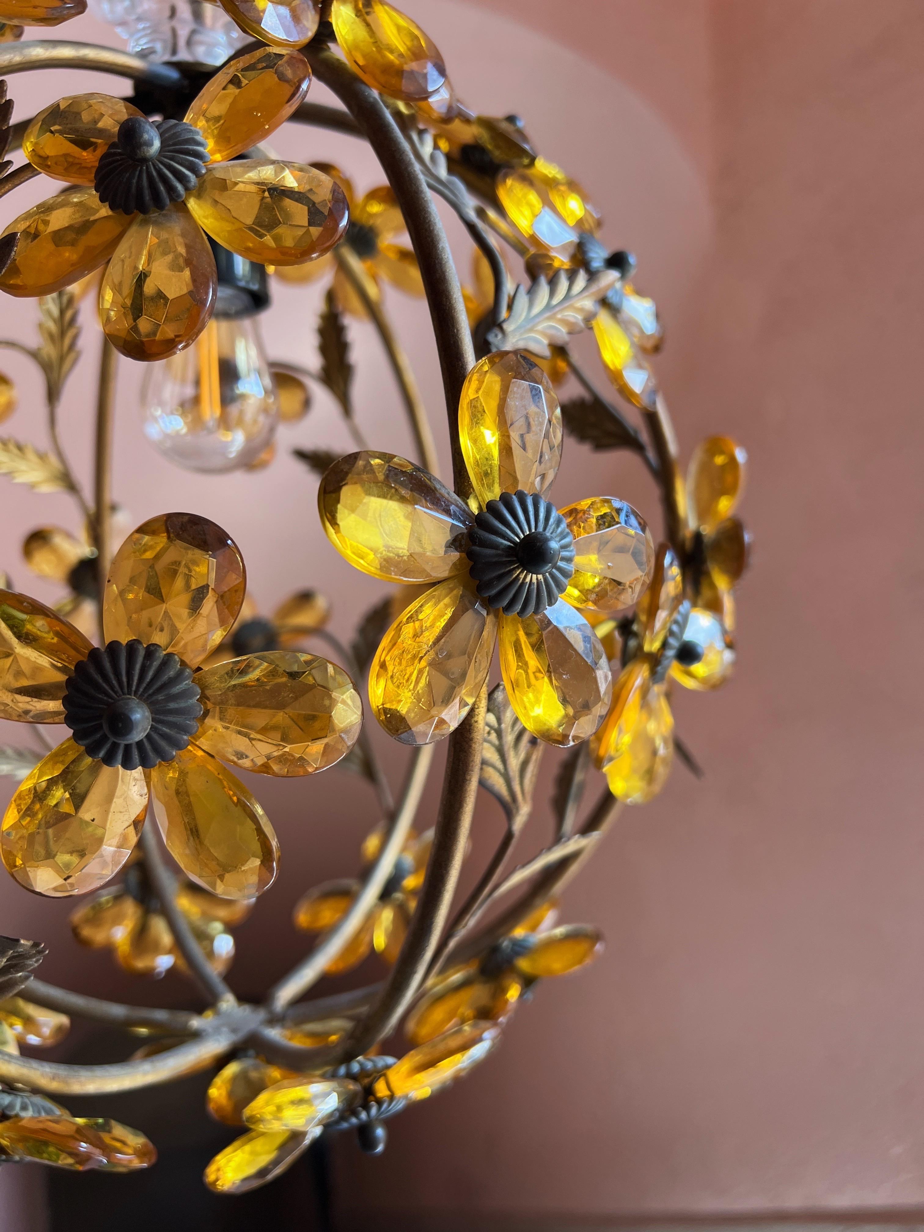 Gorgeous vintage ball ceiling chandelier with prisms and floral details, reminiscent of Maison Baguès. This 1940s metal and crystal flower pendant features a charming gilt metal lantern adorned with amber-colored crystal glass petals, forming