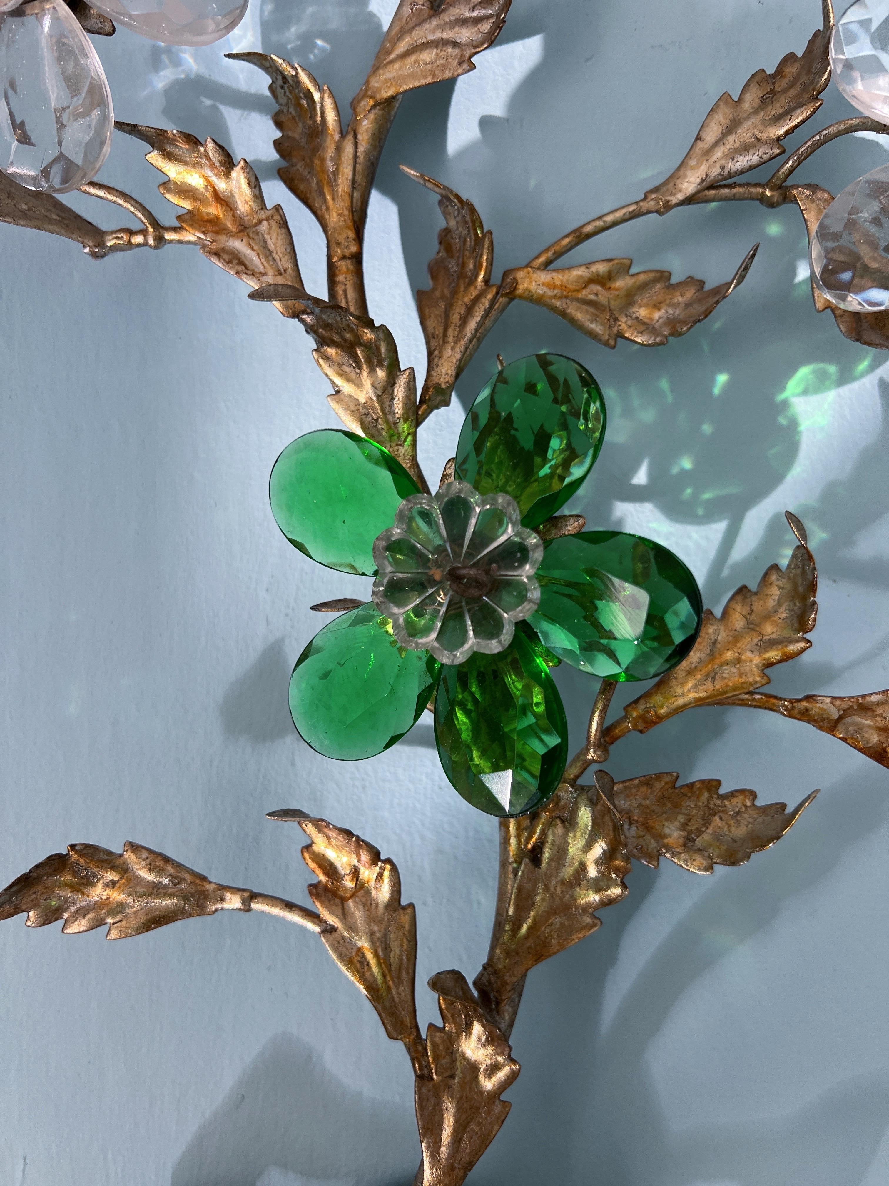This stunning 1980s wall light by the renowned French Maison Baguès is a true work of art, almost sculptural in its grandeur. Crafted with exquisite attention to detail, the light features green and clear crystal glass petals arranged in a delicate