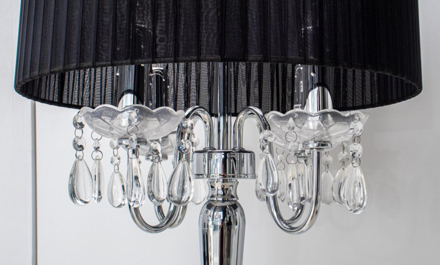 Hollywood regency crystal table lamp in the manner of Kartell, with mercury glass baluster support hung with crystals beneath a black shirred silk drum shade. 

Dimensions: 30