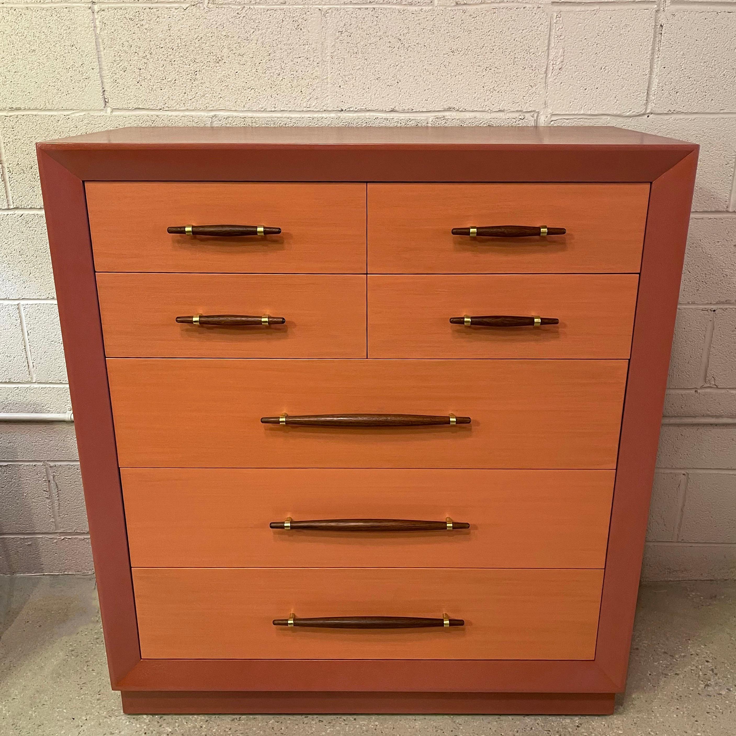 Outstanding, mid-century, Hollywood regency, mahogany dresser by John Stuart features a custom finish with opaque blush, beveled edge surround and contrasting coral stained drawers that allows some grain to show through with stained mahogany pulls