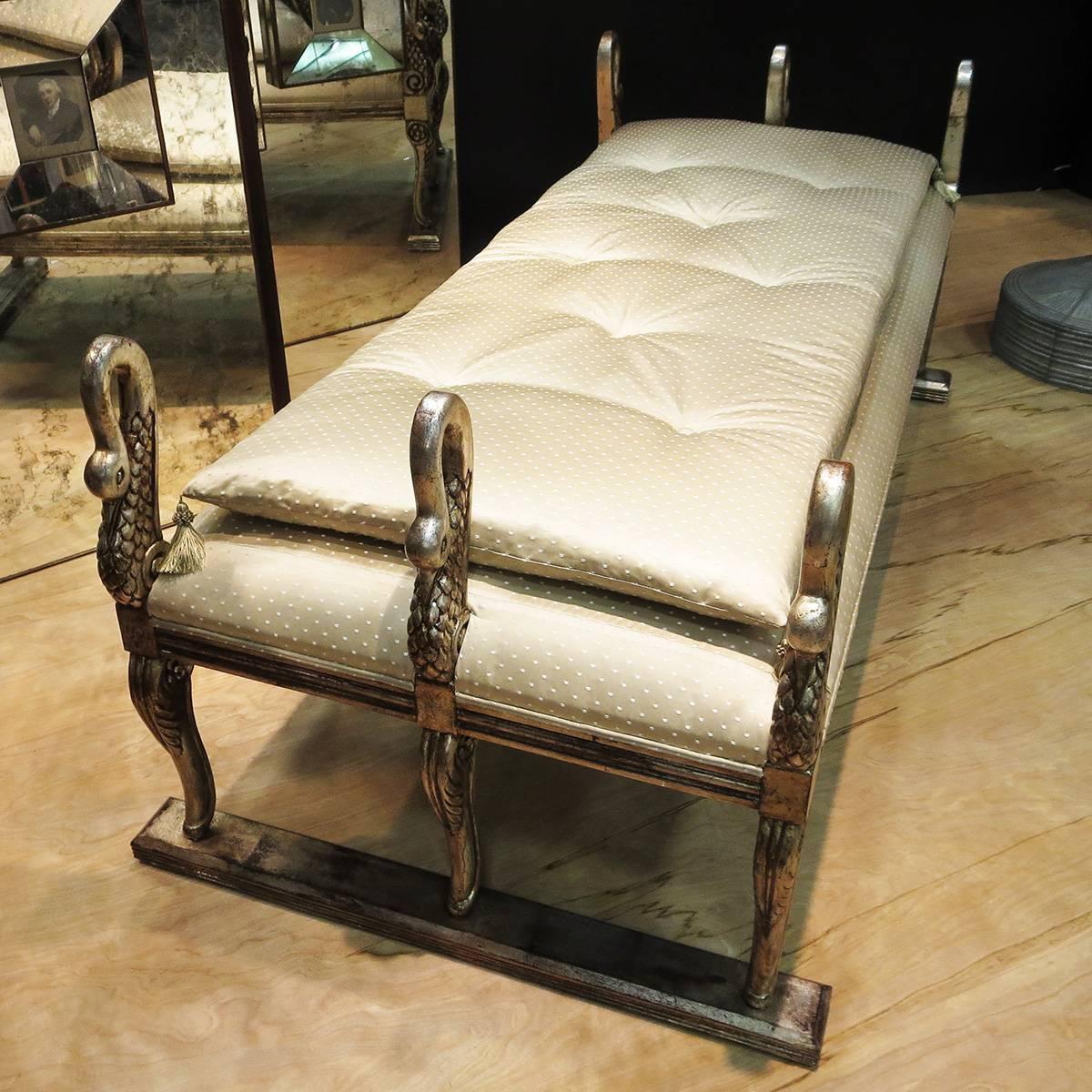 Add a little romance to any room with this fabulous daybed! The body of the bed is carved wood, with six exquisite swans. They have been finished in an antiqued silver leaf, to great effect. The upholstery has been re-done in a high sheen cream
