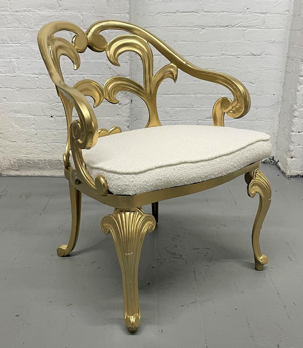 Hollywood Regency decorative gold metal armchair with a Bouclé seat.