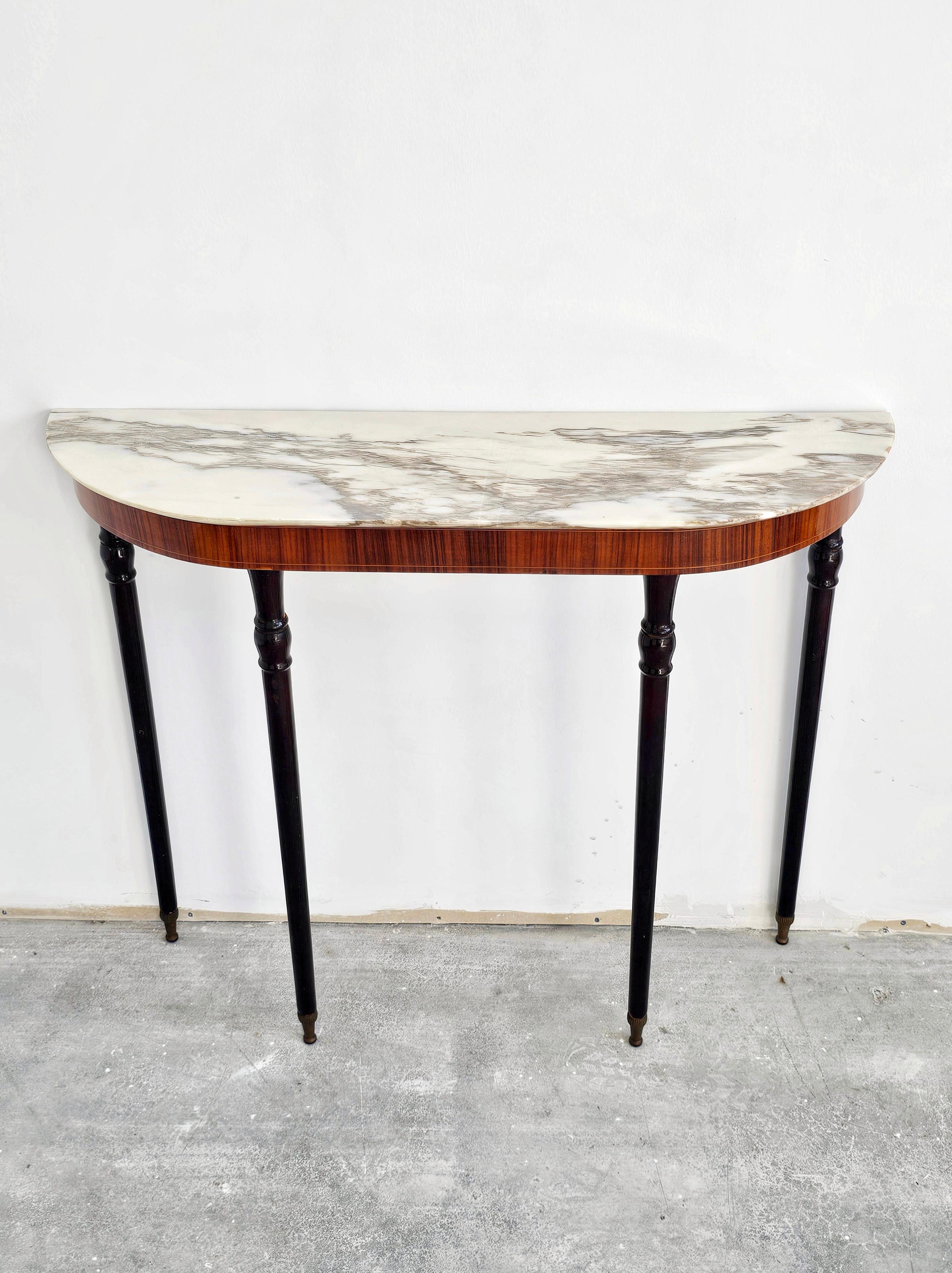 In this listing you will find an elegant Hollywood Regency Demilune Console table with the marble top done in calacatta gold. Made in Italy in 1950s.

Very good vintage condition with some signs of time and use.

When purchased the console table
