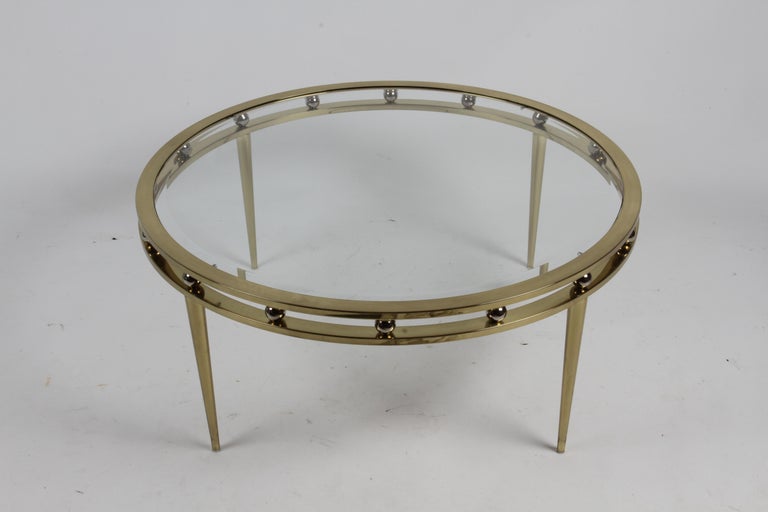 Classic 1970s Mid-Century Modern style DIA or Design Institute America brass round coffee table with beveled glass, chrome balls separating the top and tapered legs. Labeled.