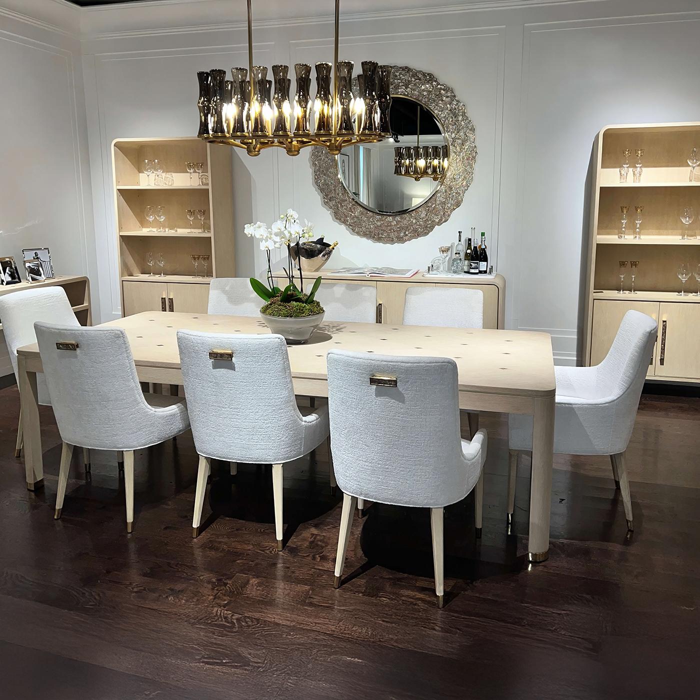 Meticulously artisan made, it is a luxurious statement piece for individuals who embrace an elegant approach to life. Shown in a light wood martini finish, the expansive tabletop is adorned with a refined diamond inlay pattern, offering a