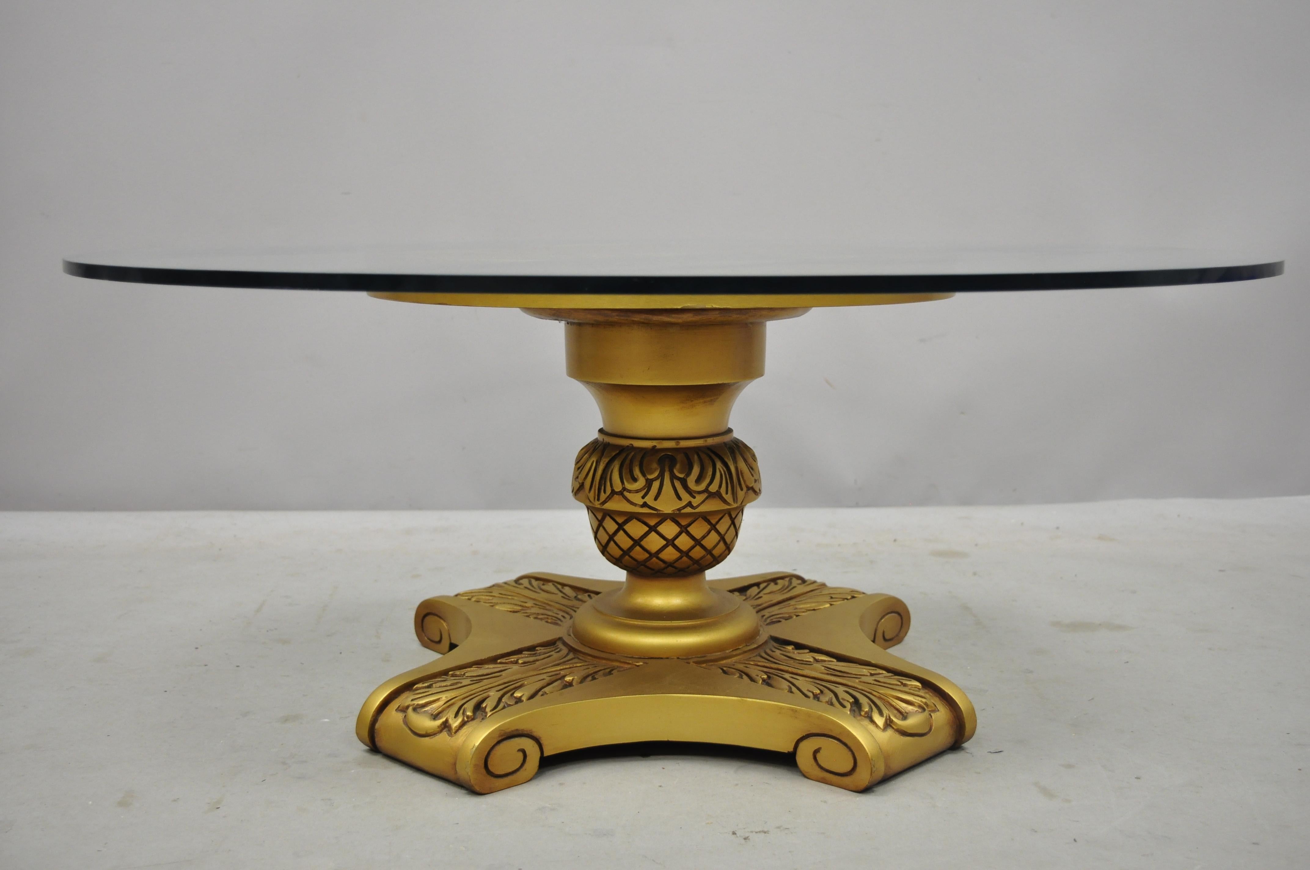 Vintage Hollywood Regency Dorothy Draper style gold pedestal base glass top coffee table. Item includes a solid wood carved pedestal base, gold gilt finish, round glass top, great style and form,
circa mid-20th century. Measurements: 15