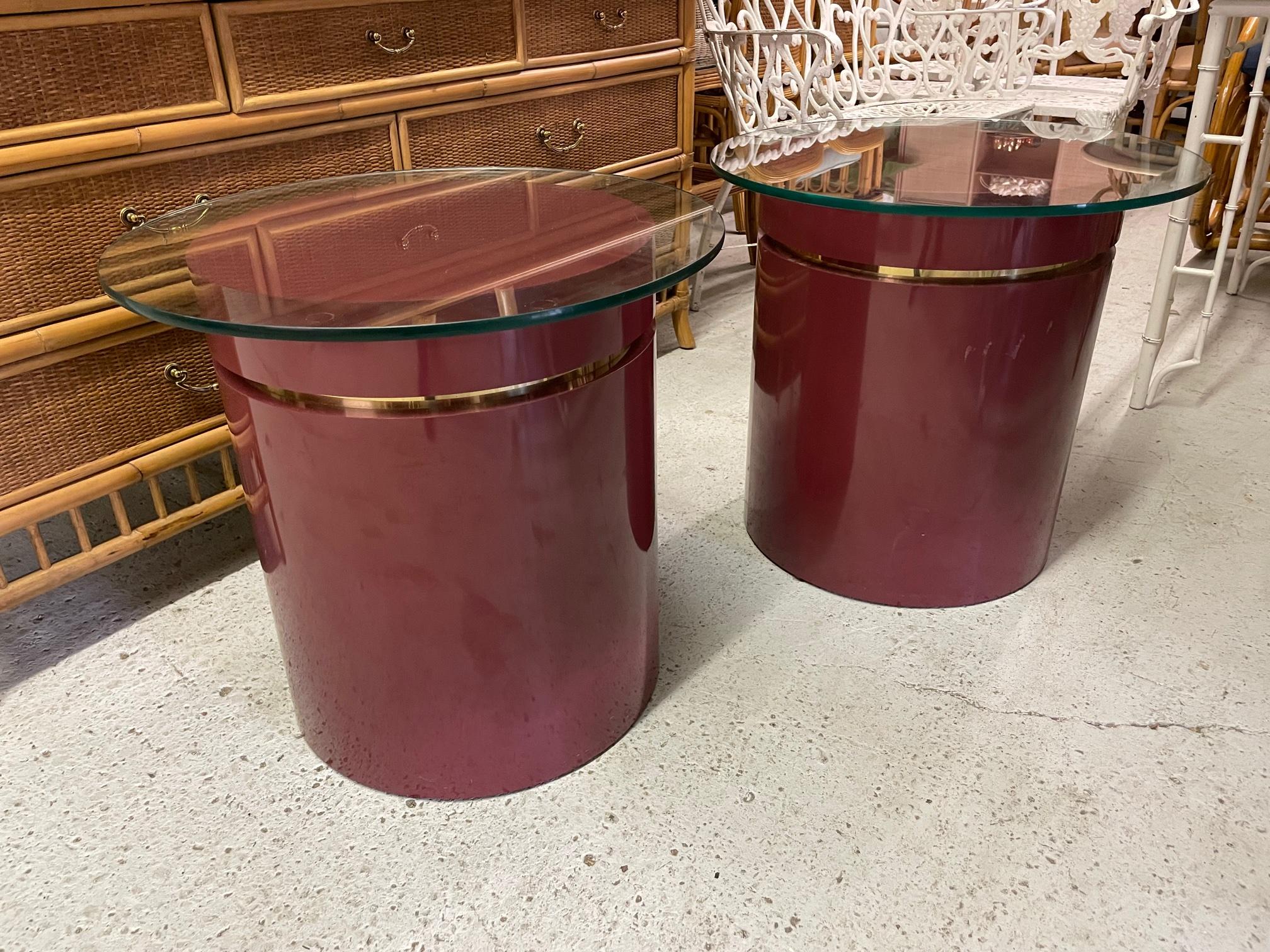 Pair of 1980s drum shaped end table feature brass ring accents and a heavy glass top. Good condition with minor imperfections consistent with age (see photos).
      