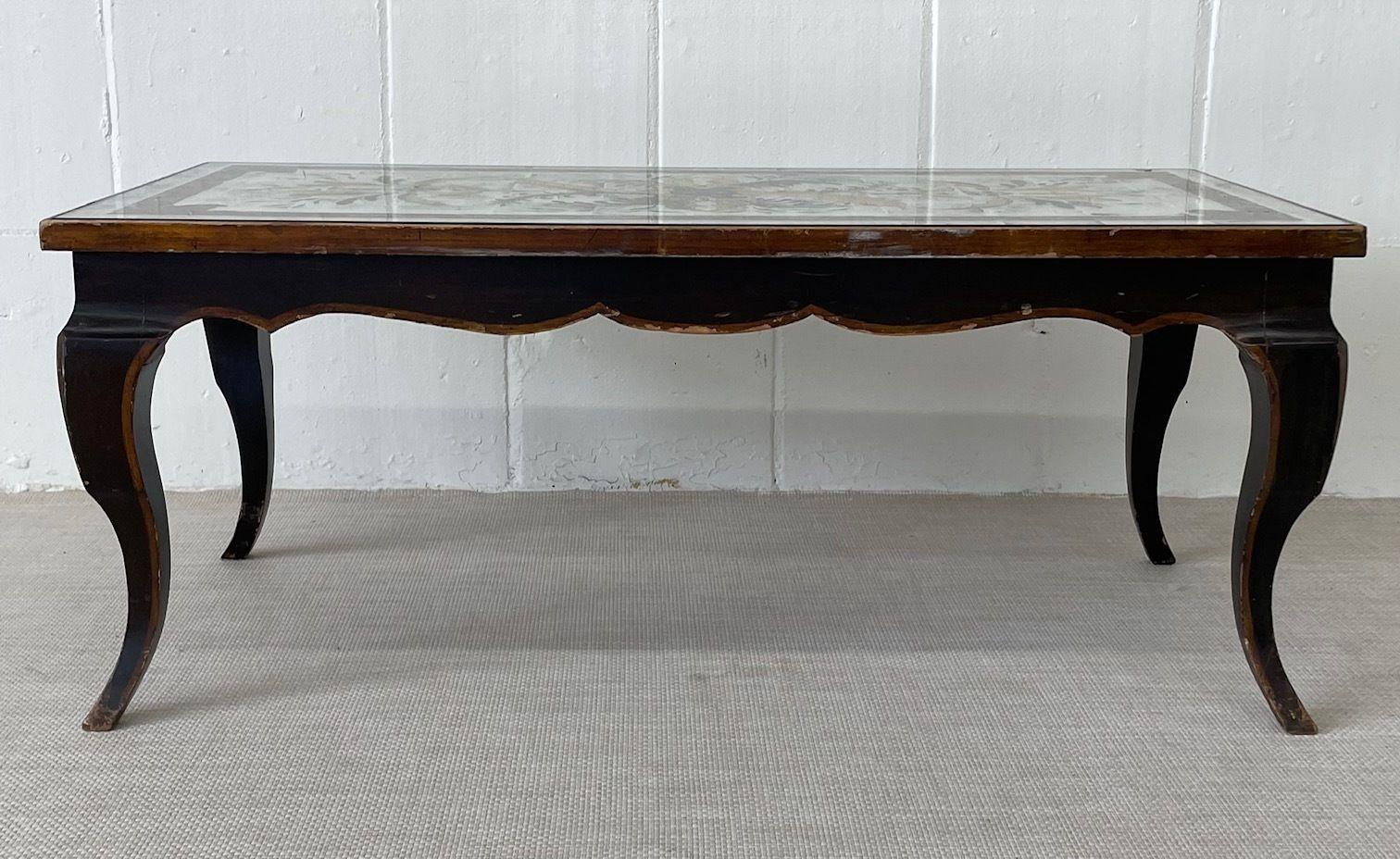 A Maison Jansen Hollywood Regency Ebony Coffee Table. Eglomise. 
Stunning floral design eglomise silver gilt glass top table on an ebony base with clay and glit decorations attributed to Maison Jansen. 
 
 
 
 
ZXX