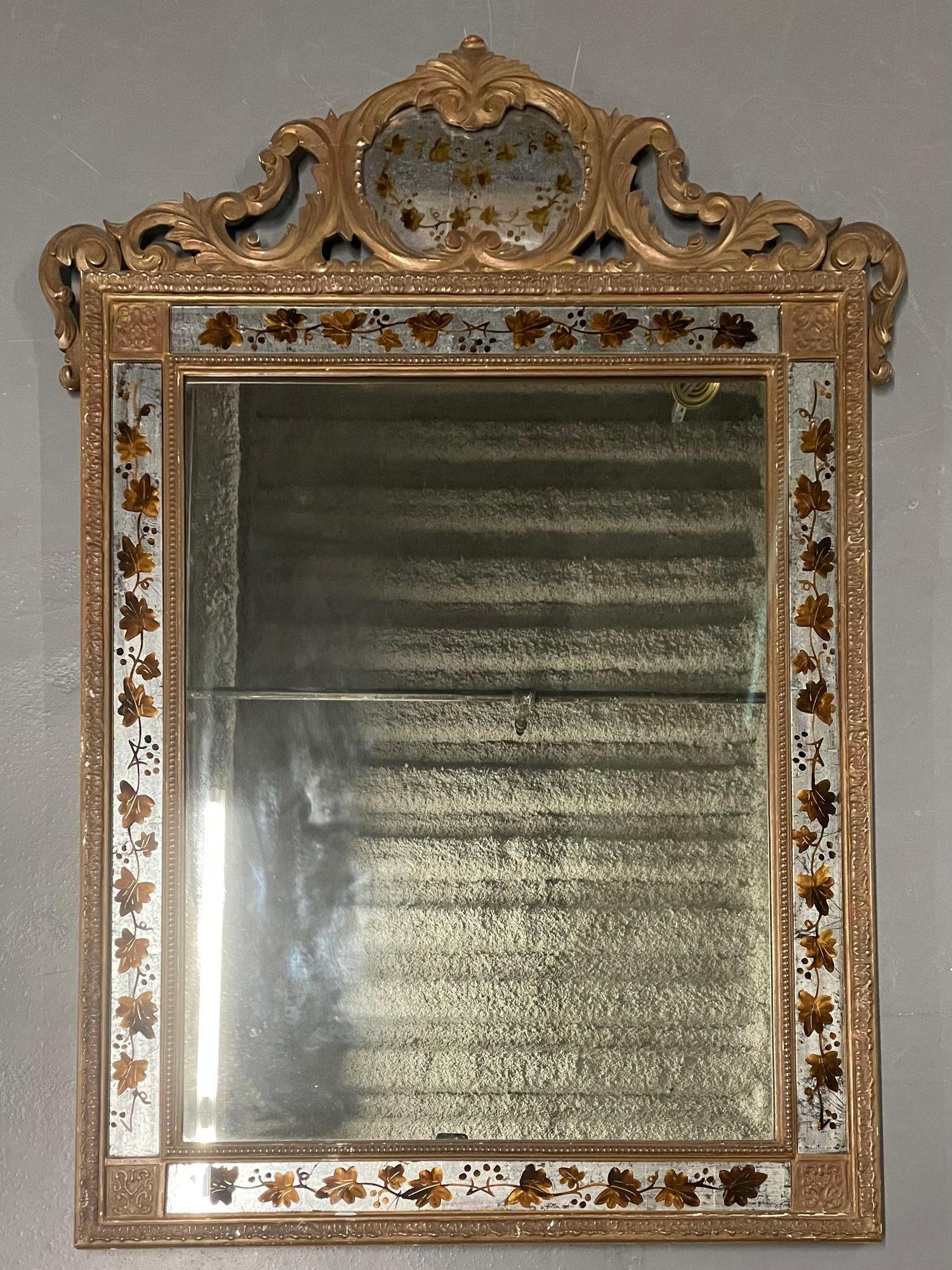 Hollywood Regency Eglomise Decorated Maison Jansen Wall, Pier Mirror

A Jansen Eglomise Wall, Console or Over the Mantle Mirror. A large and impressive mirror having an eglomise silver and gold designed border flaked by giltwood framing around a